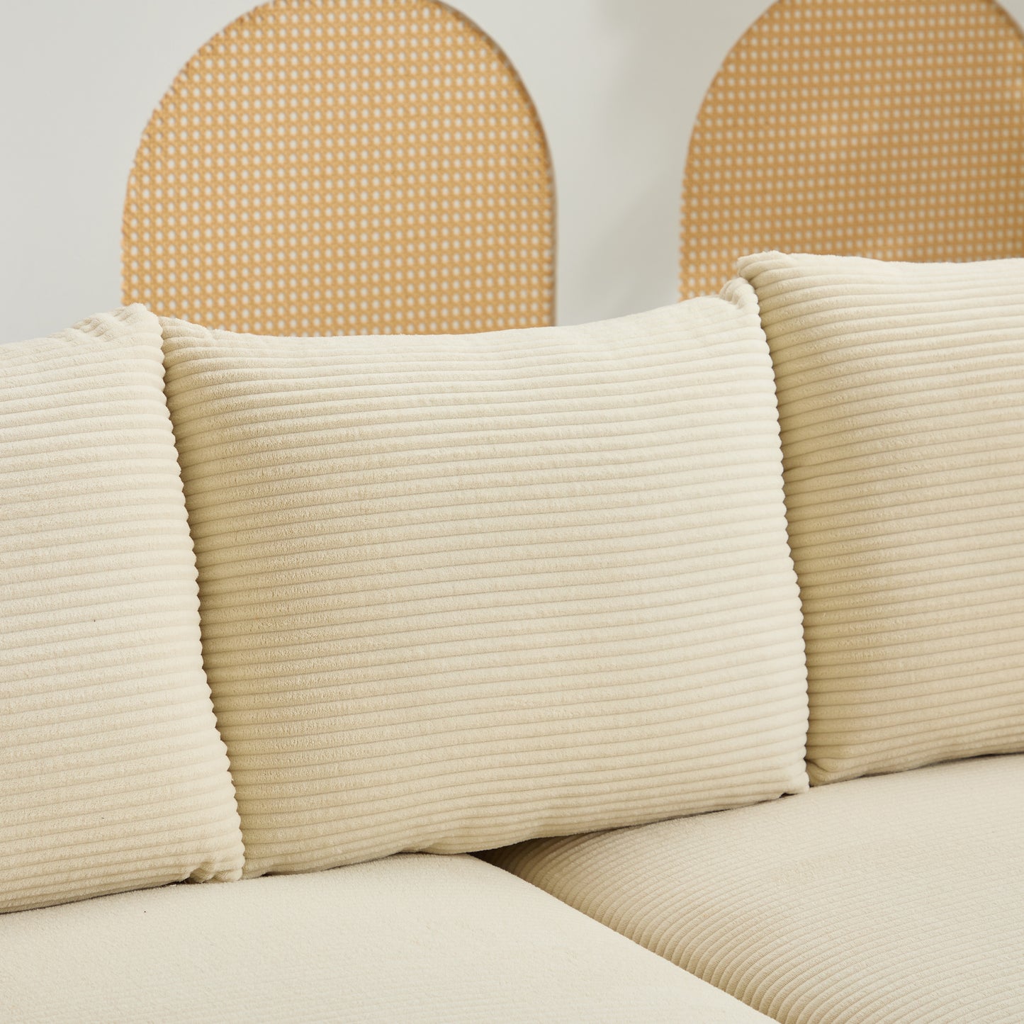 Cream corduroy throw pillows with horizontal ribbing on a sofa