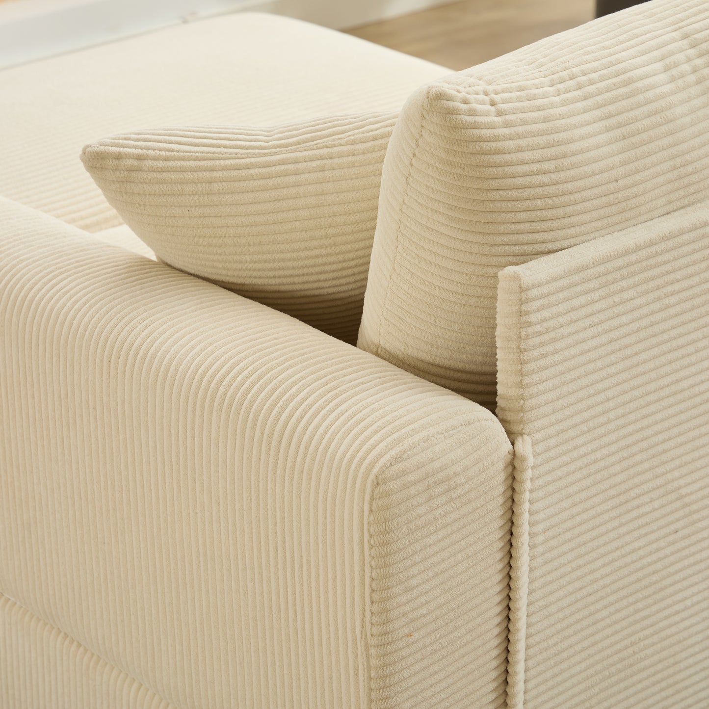 Cream corduroy sofa detail showing plush texture and rounded arms perfect for a cozy living room