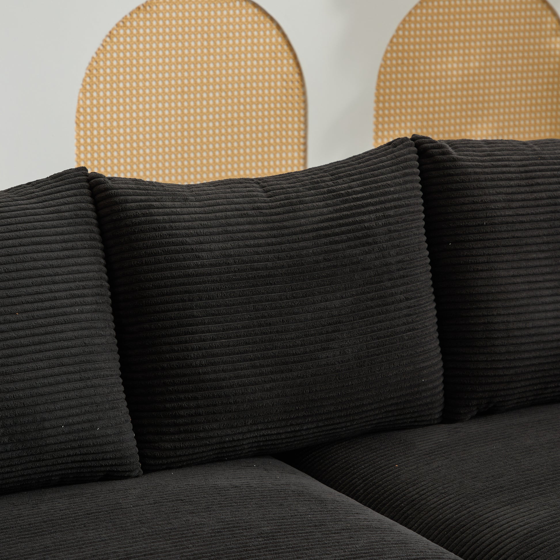 Closeup of black corduroy sofa cushions with plush texture