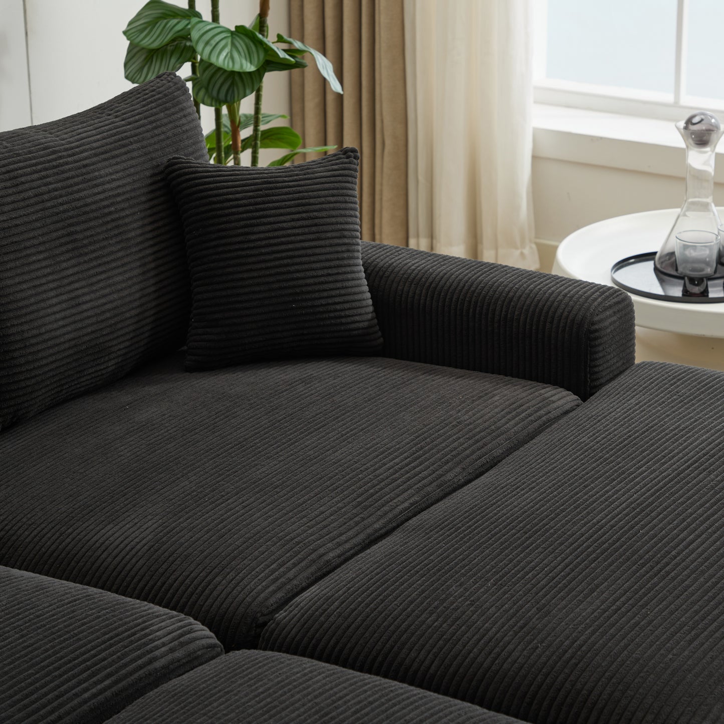 Charcoal corduroy sofa sectional with plush cushions and a decorative pillow