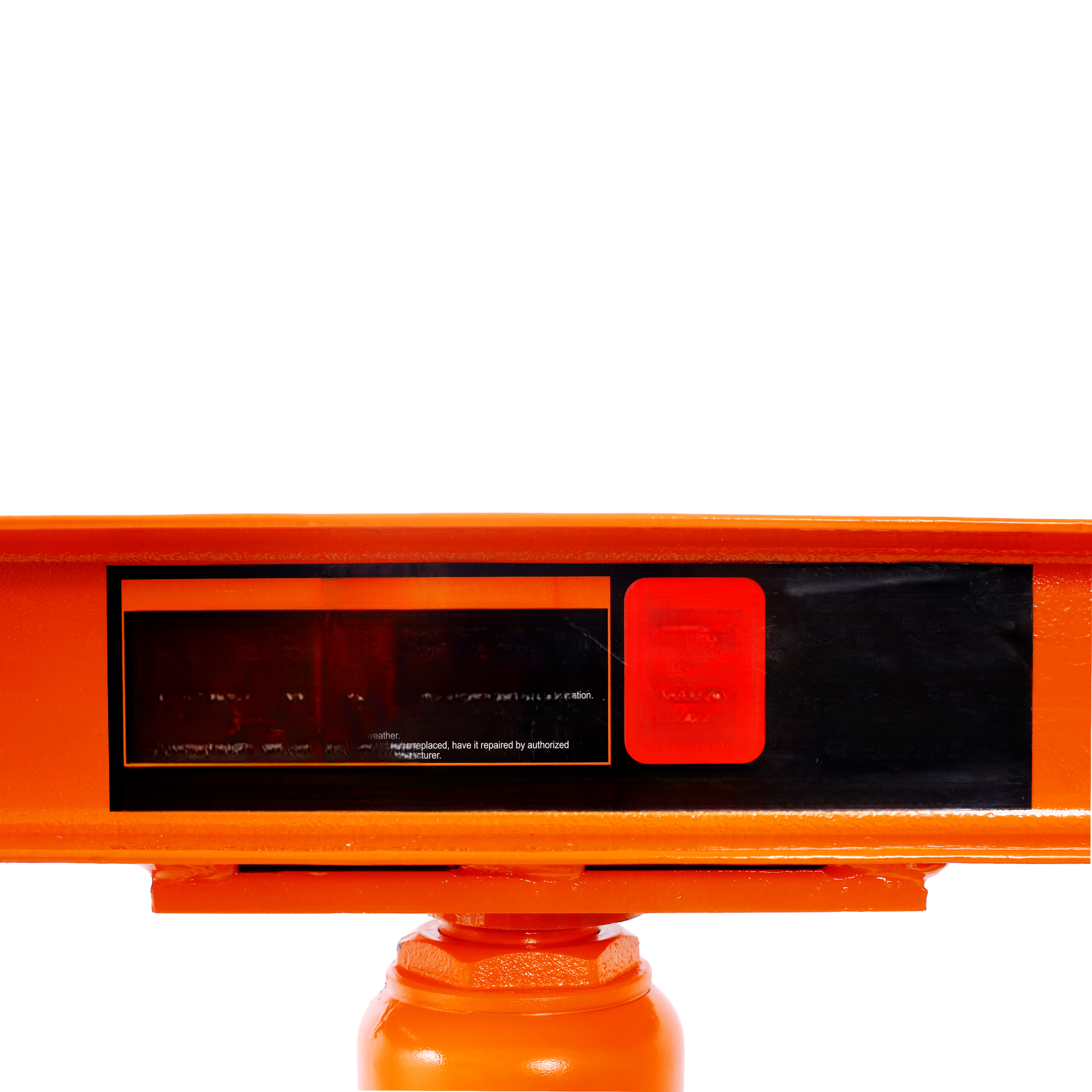 Closeup of an orange hydraulic jacks pressure plate with warning labels for proper maintenance