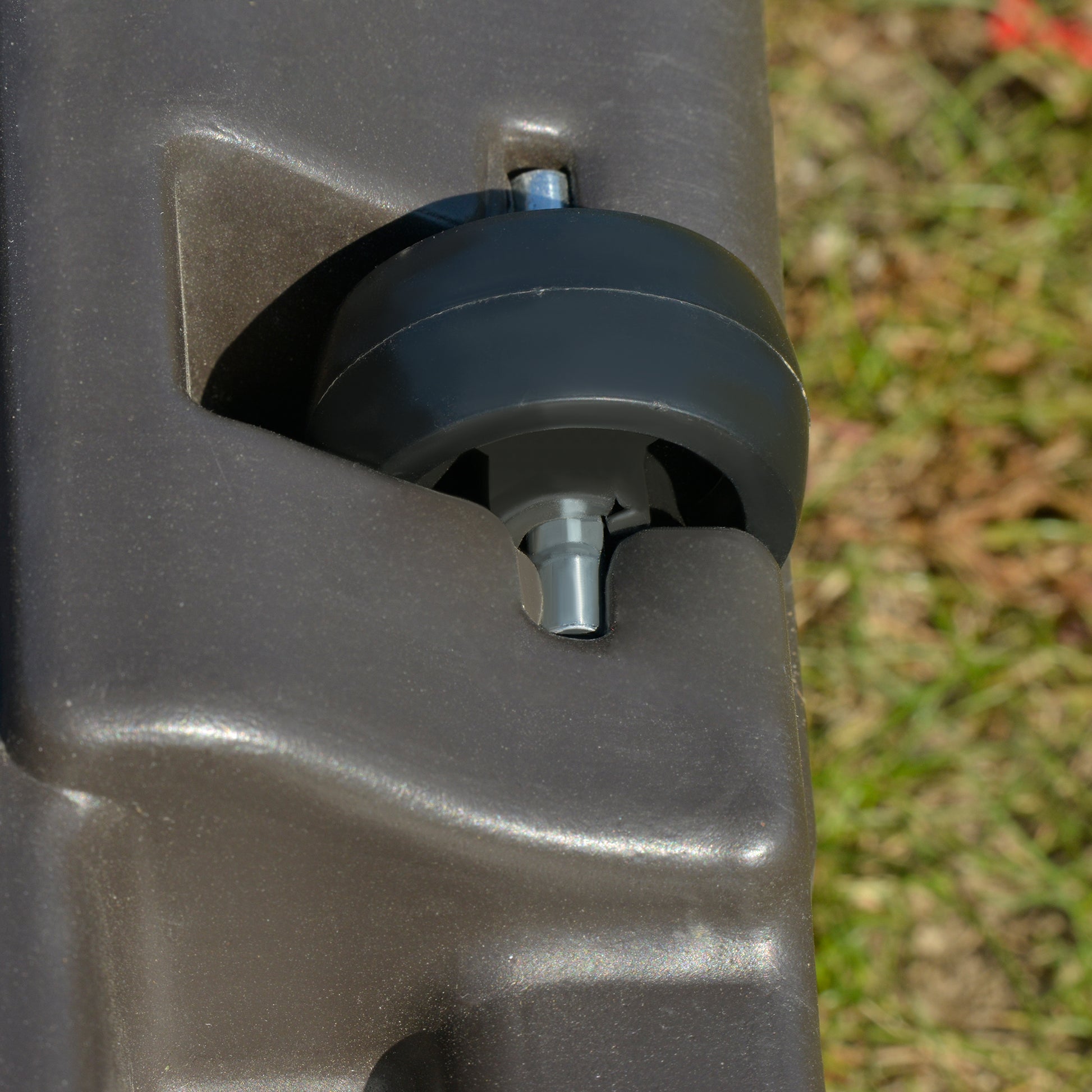 Dark gray plastic suitcase wheel and bolt assembly detail