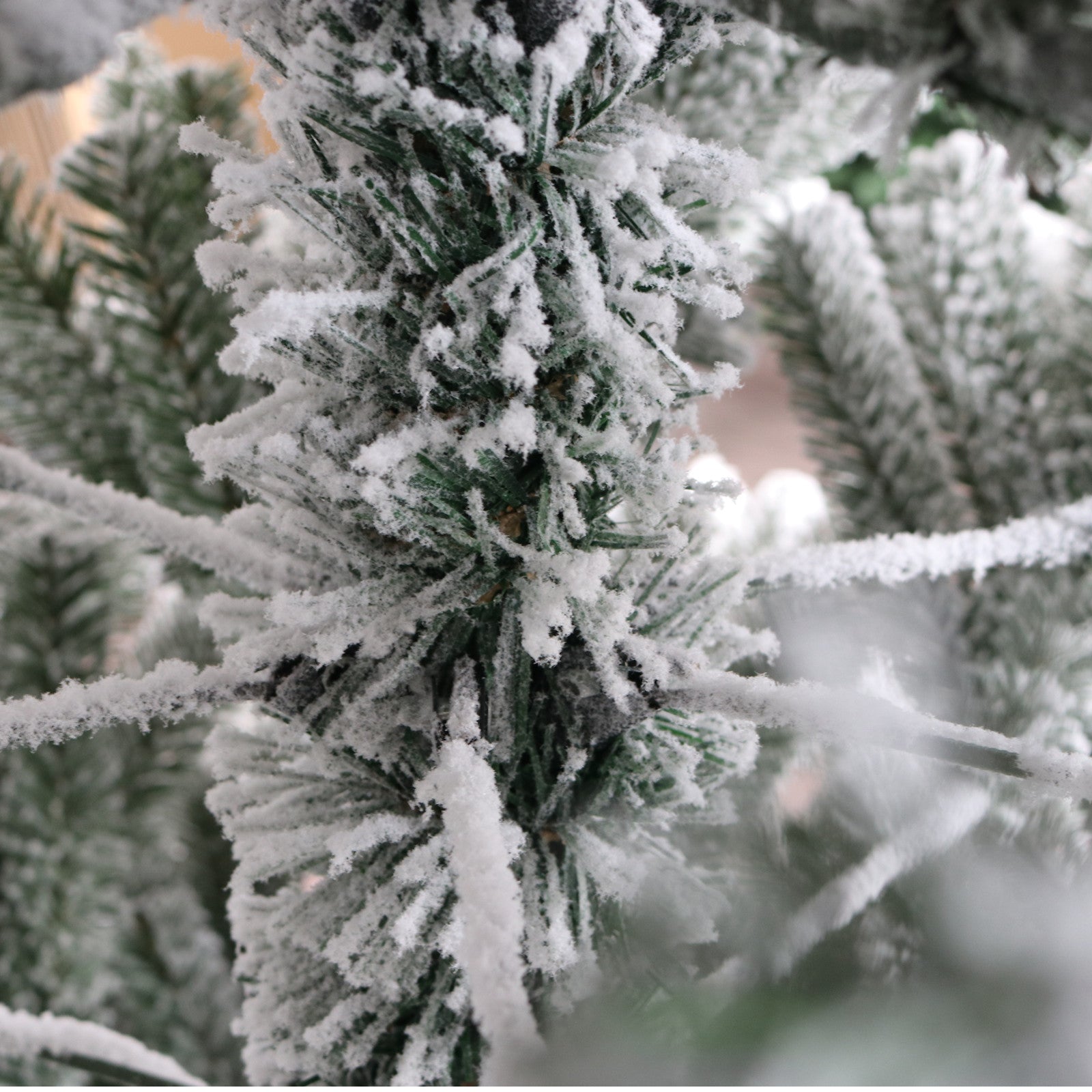 Flocked artificial Christmas tree branches with realistic snow effect