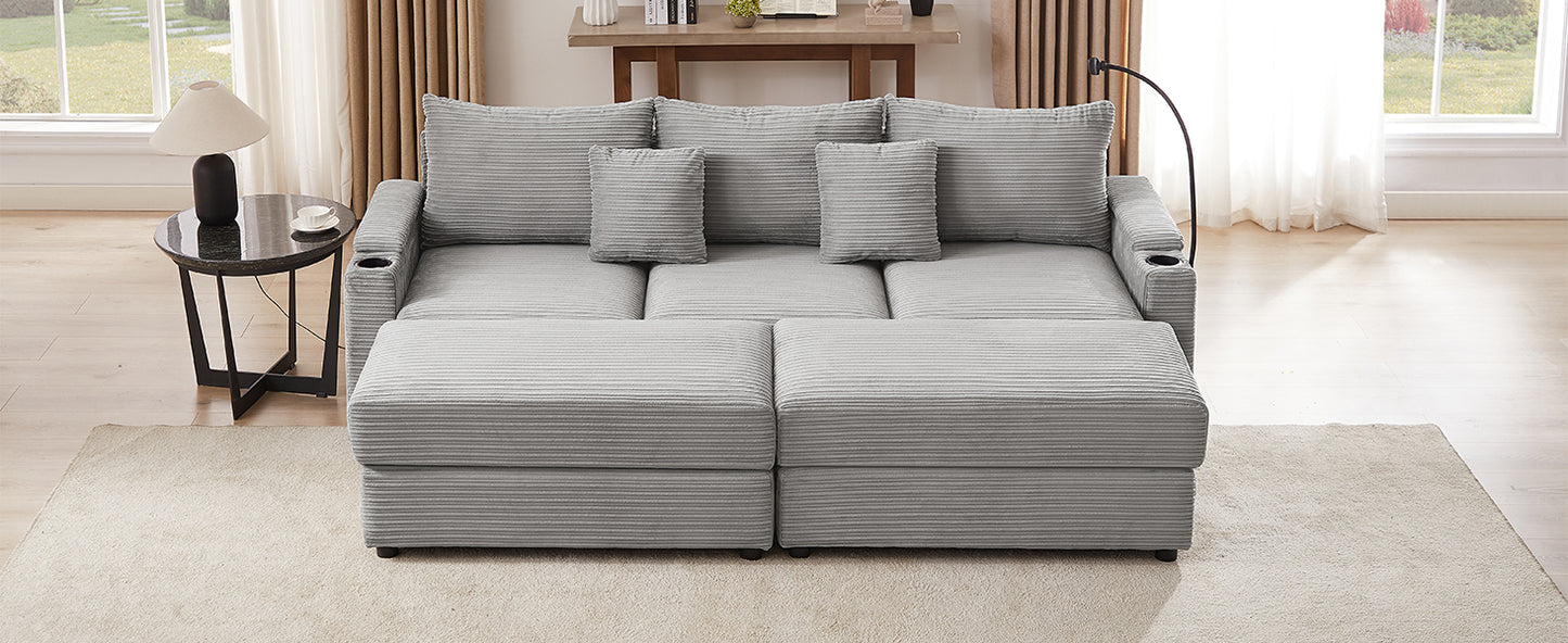 Gray corduroy sofa with multiple cushions and builtin cup holders