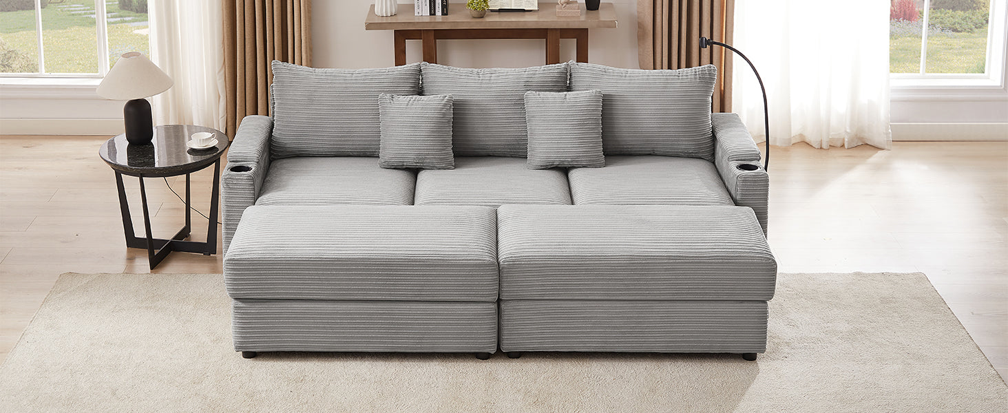 Gray corduroy sofa with multiple cushions and builtin cup holders