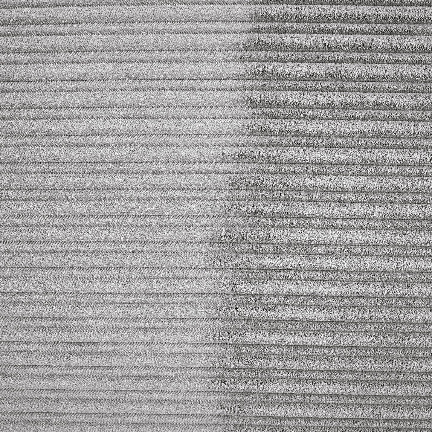 Closeup of textured grey corduroy fabric showing fine ribbing detail