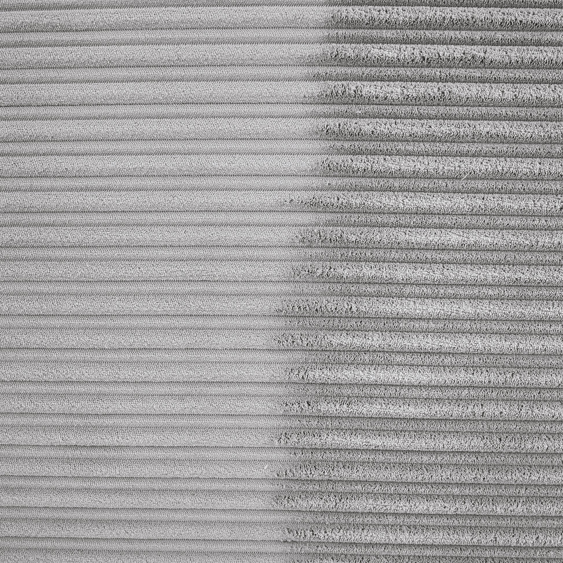 Closeup of textured grey corduroy fabric showing fine ribbing detail