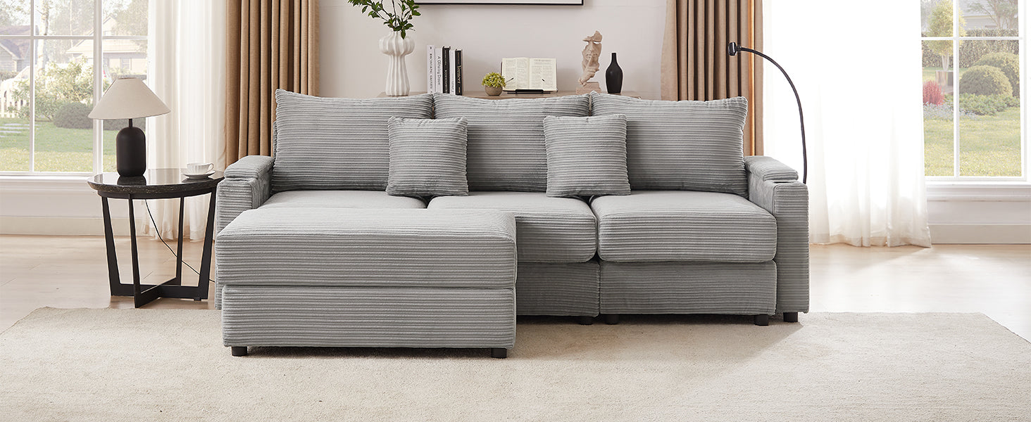 Plush grey corduroy sectional sofa with ottoman for a cozy living room setting