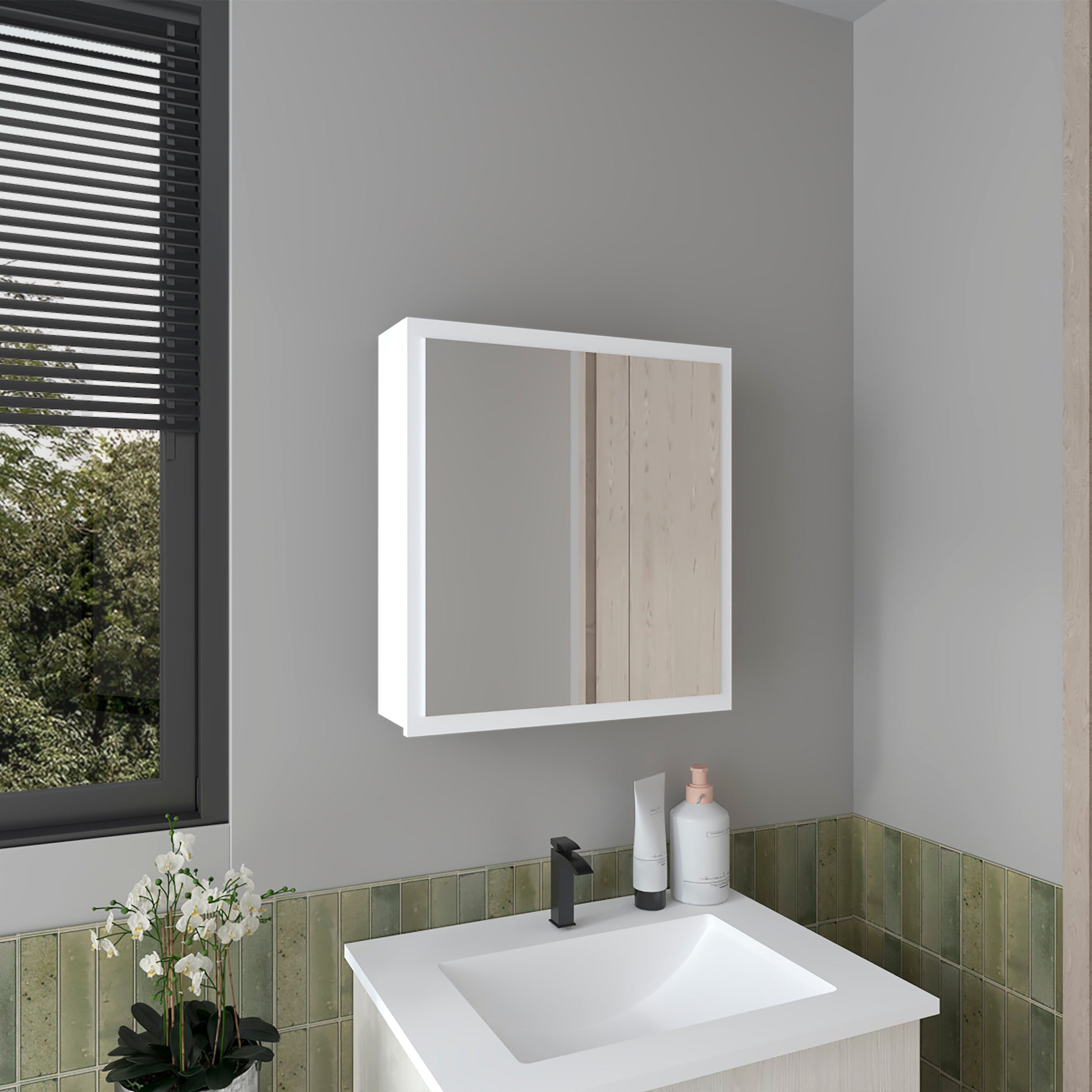 White modern medicine cabinet with mirrored doors above a bathroom sink