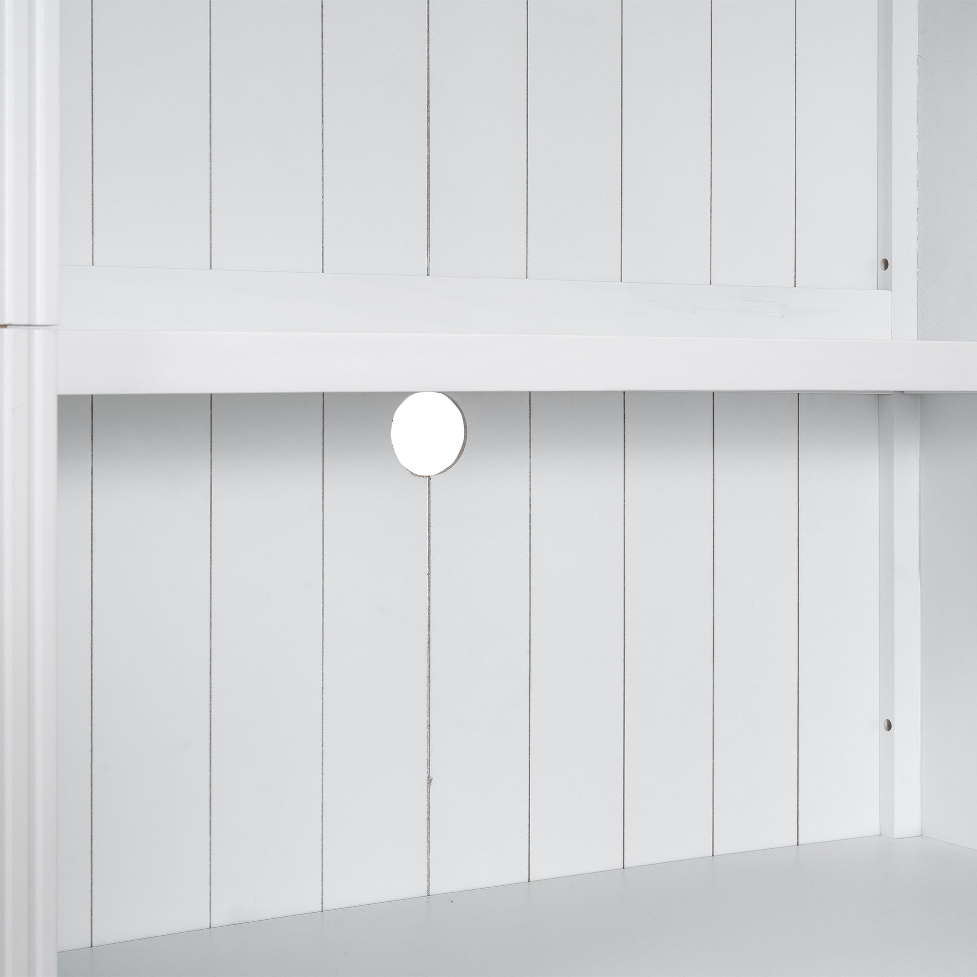 White slatted panel with a circular cable management hole on a media console