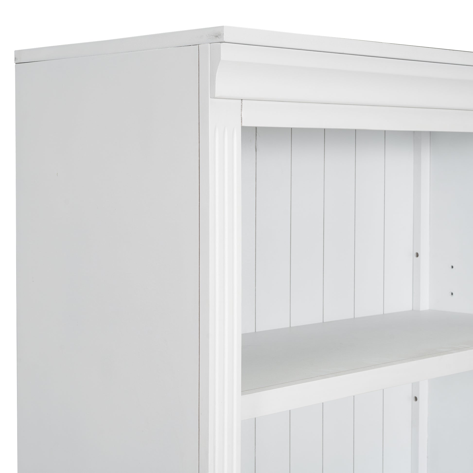 Closeup of white wooden bookshelf with decorative molding and slatted back panel
