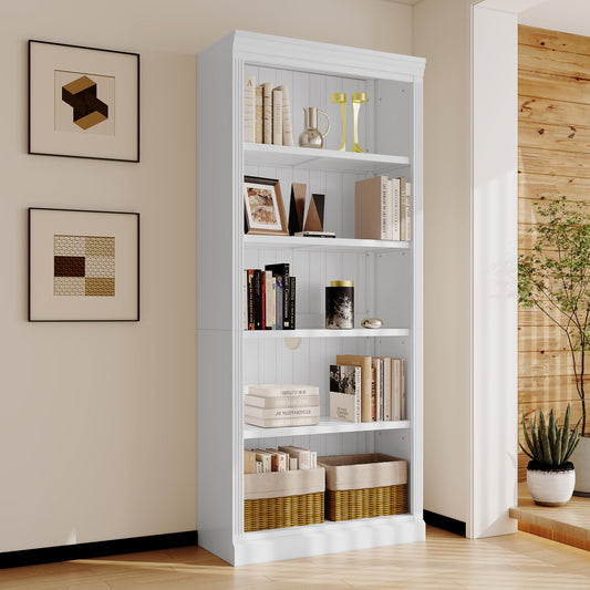 White freestanding bookshelf filled with books and decorative items