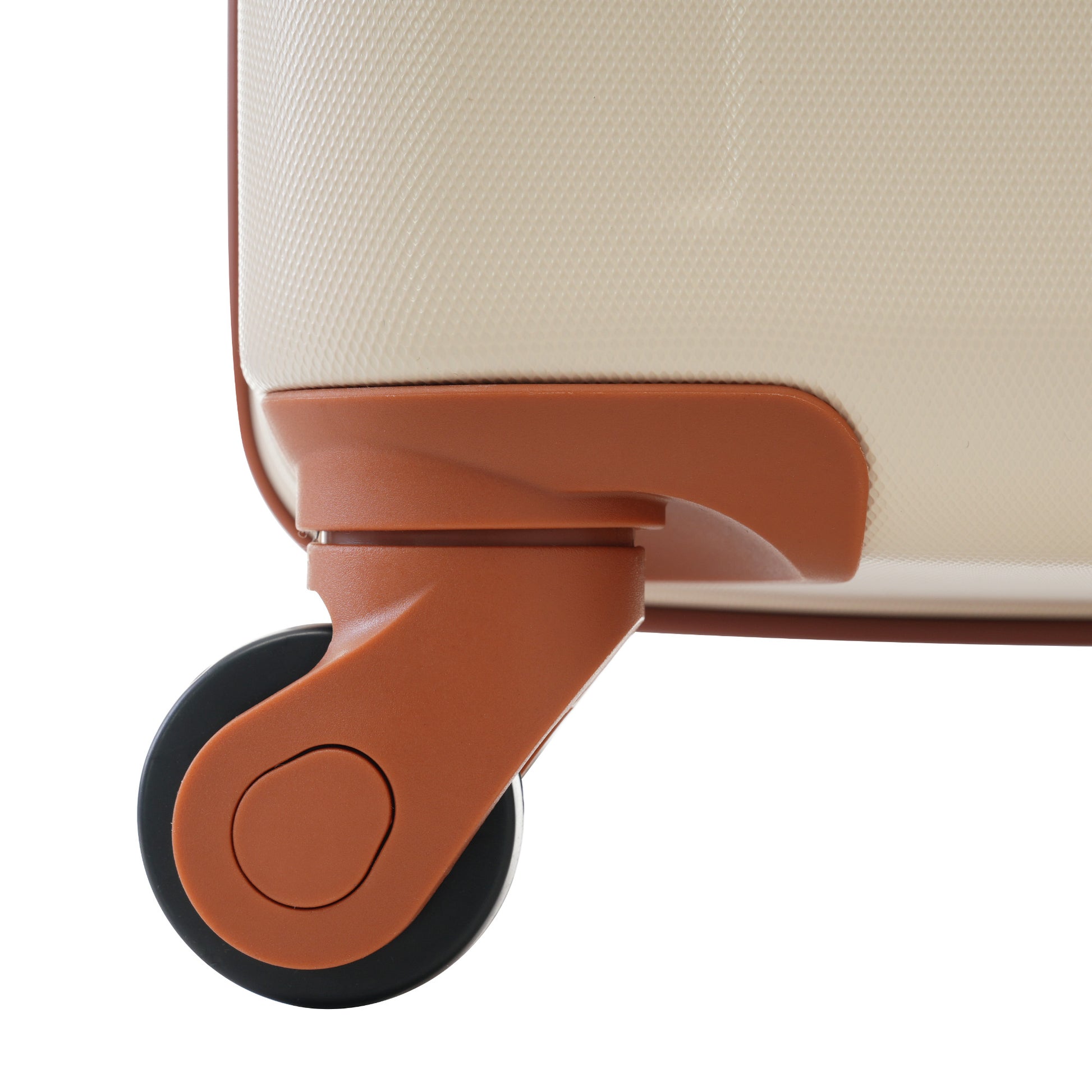 Closeup of a textured beige suitcase side with a brown wheel and housing