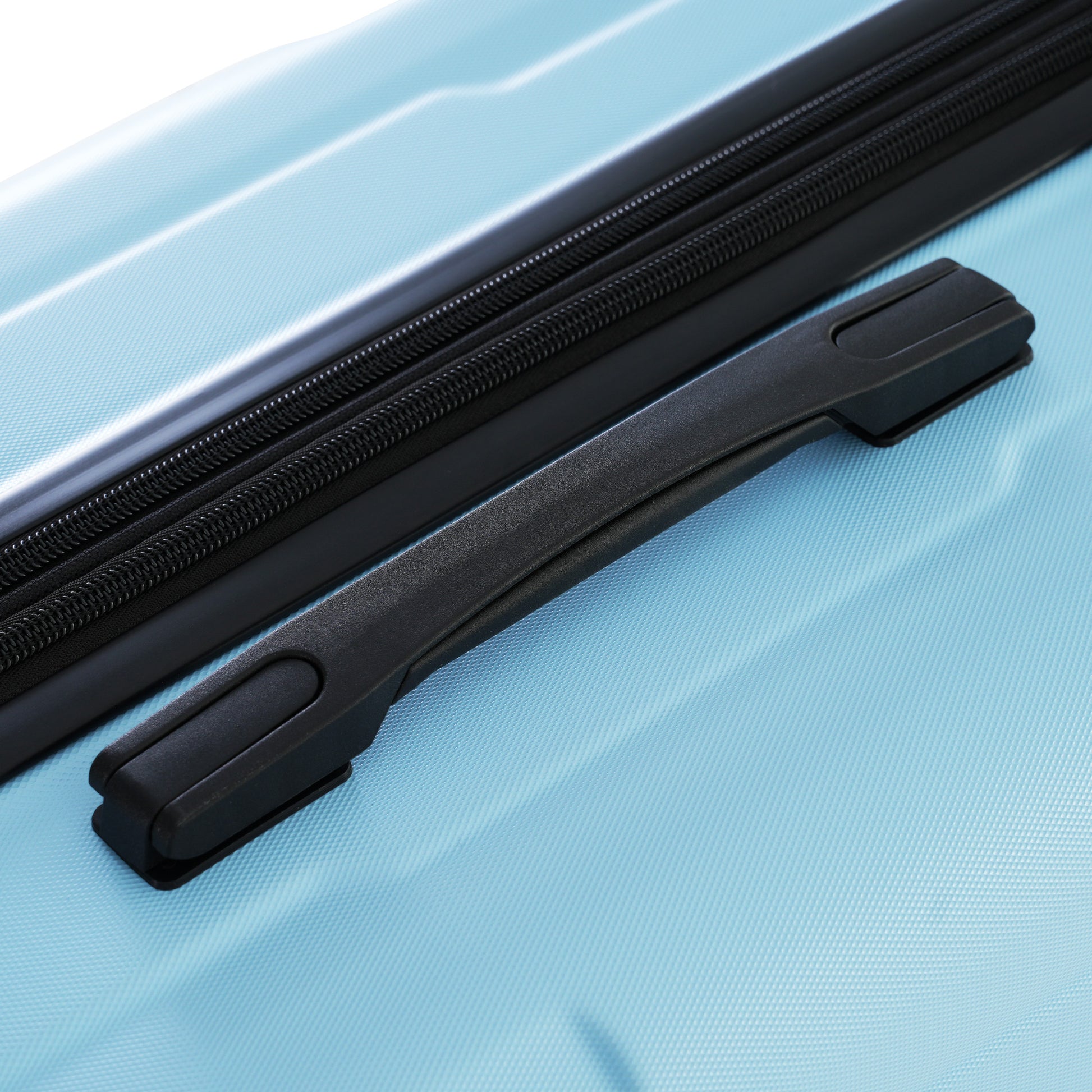 Close up of a light blue hardshell suitcase with black handle and zipper detail