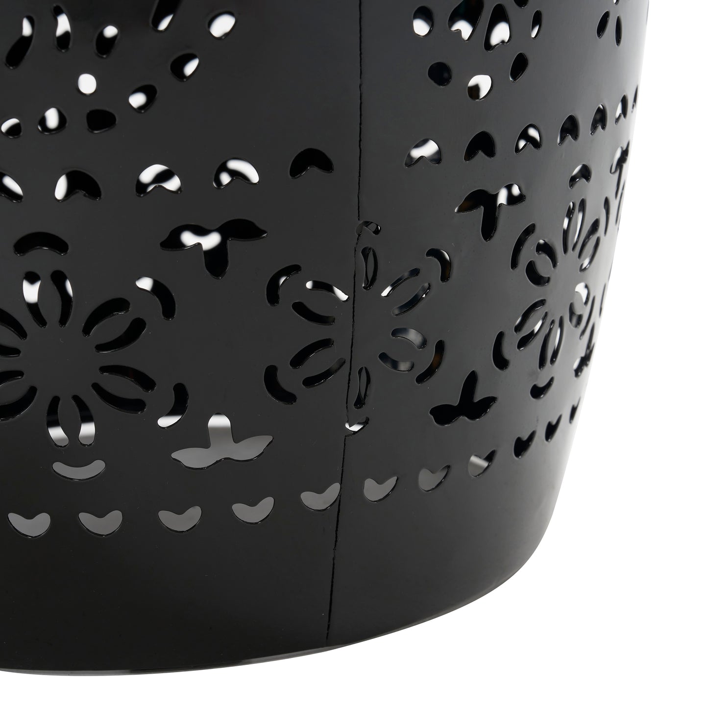 Black metal basket with intricate floral cutouts ideal for decorative storage