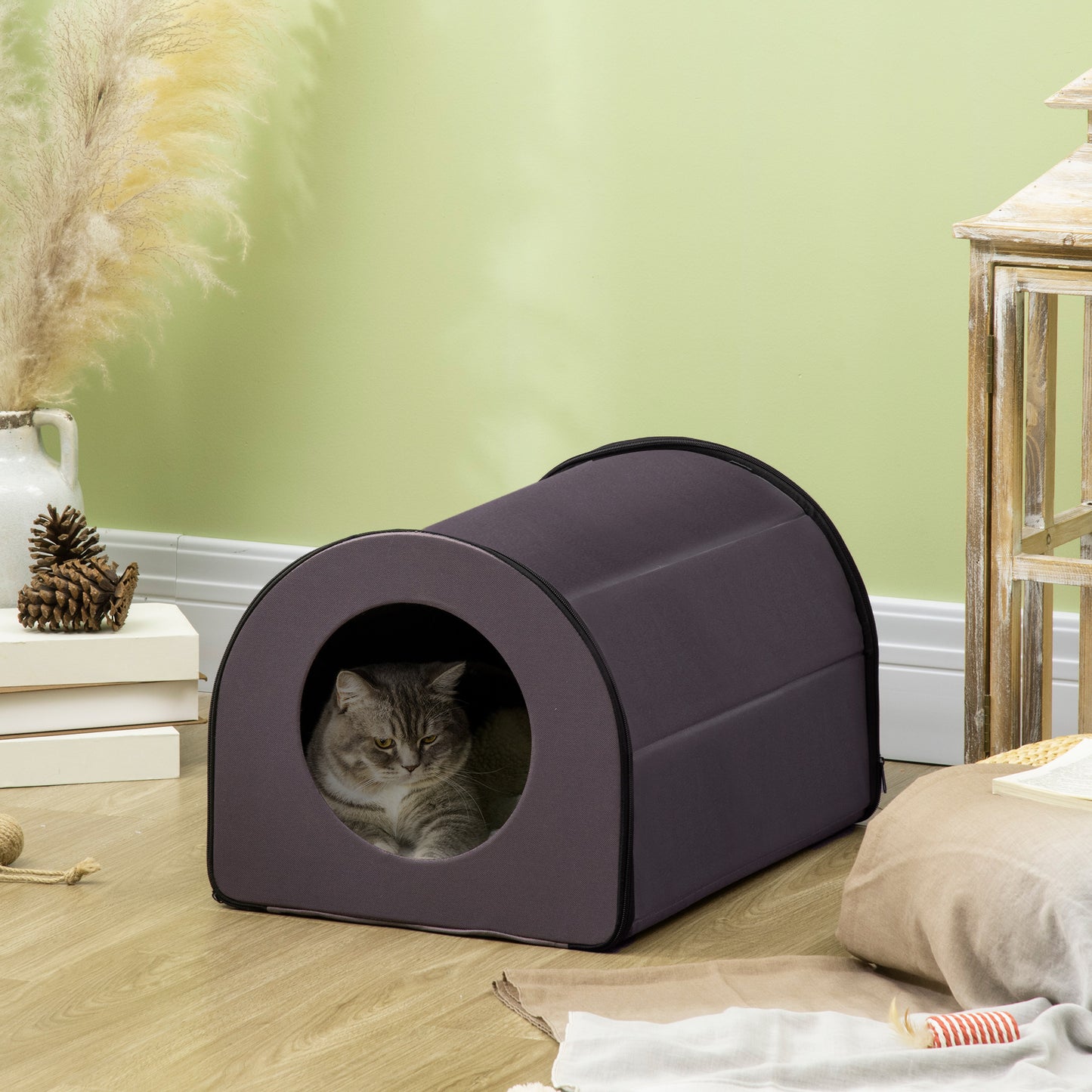 Plush grey cat napping in a cozy enclosed cat bed with circular entrance