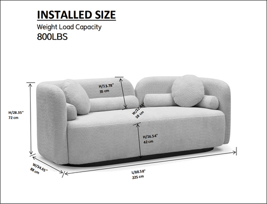 Light gray boucl modern sofa with curved arms and circular throw pillows