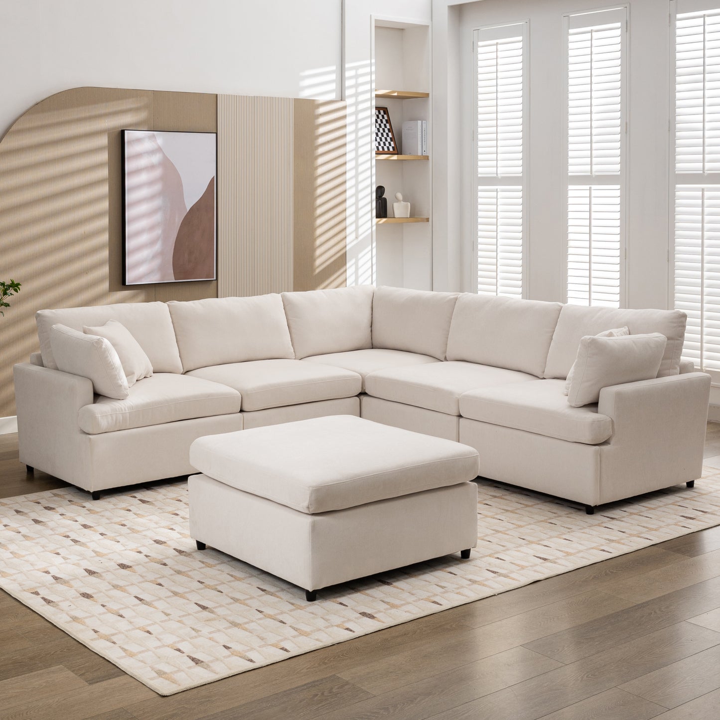 Cream sectional sofa with ottoman on a patterned rug