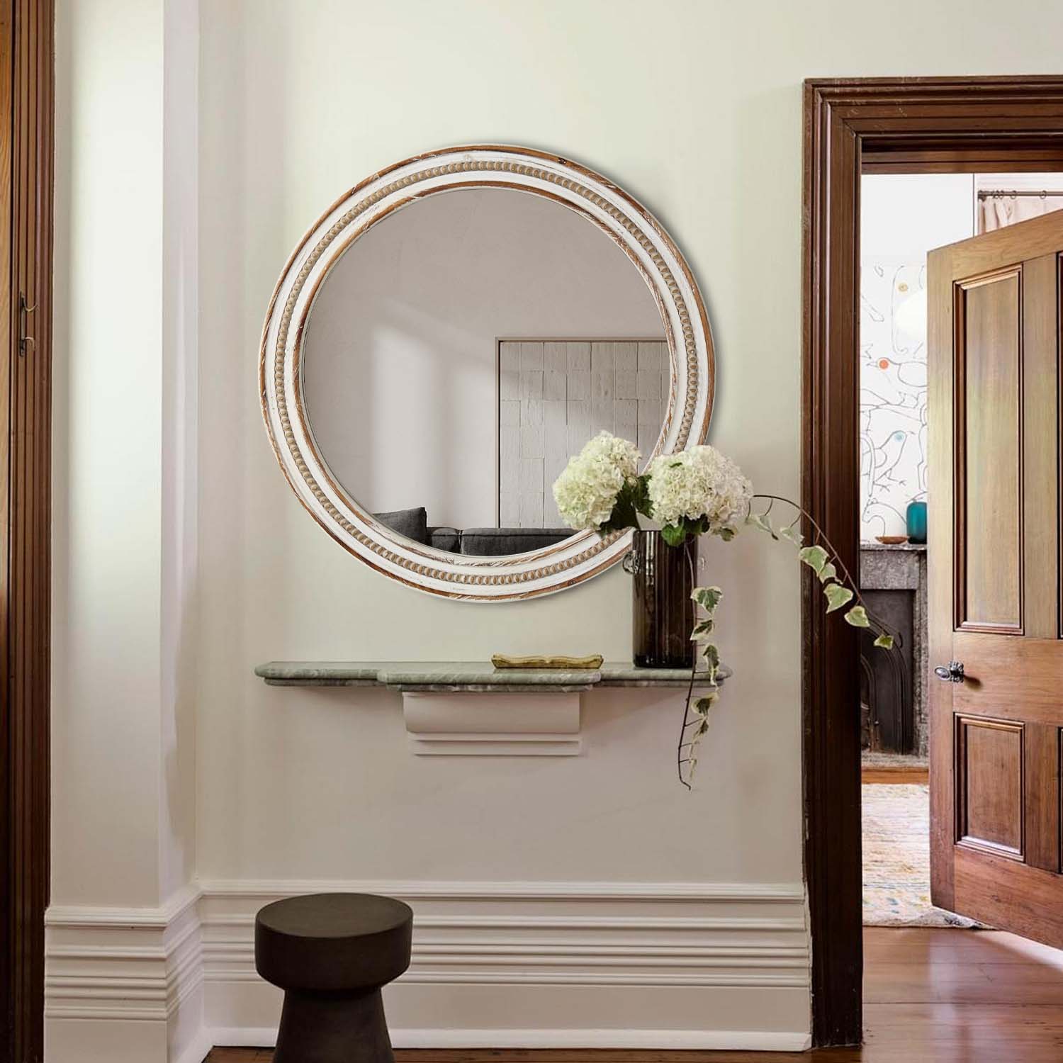 Round distressed white wood frame mirror with beaded detailing and bronze accents