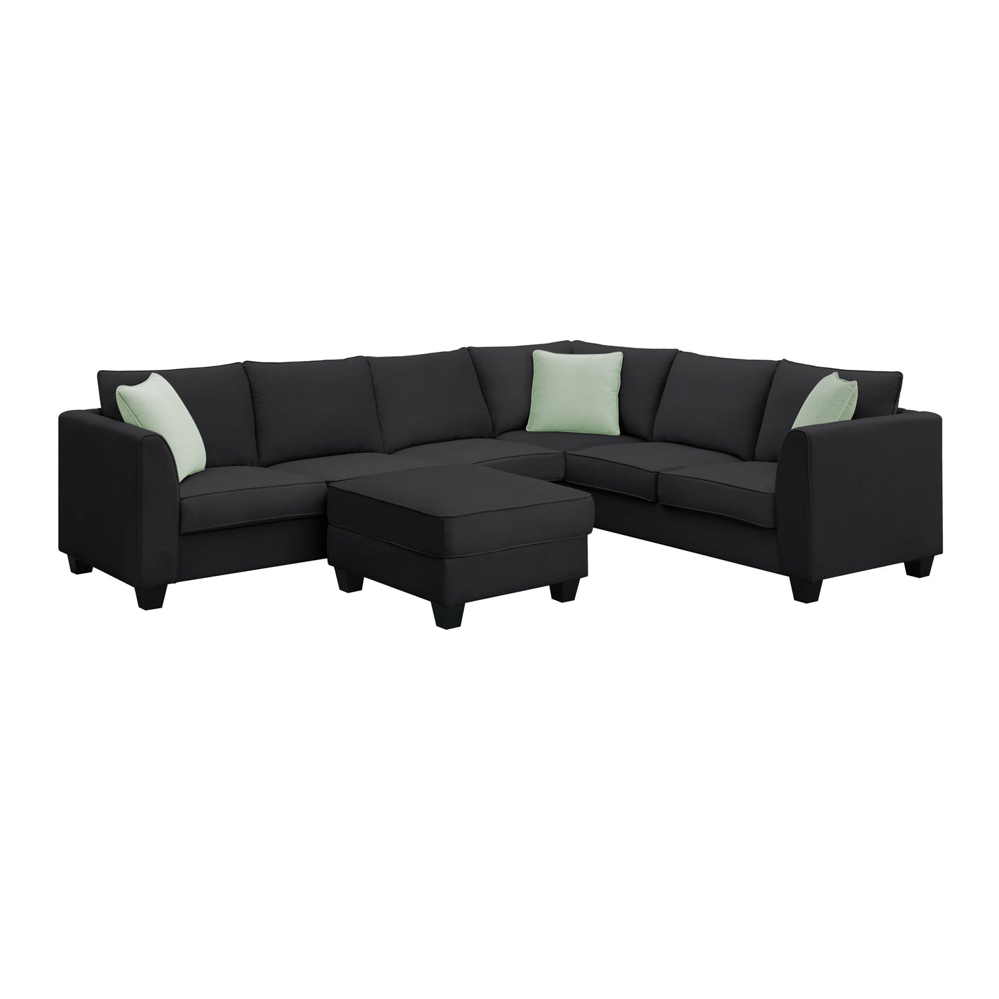 Dark grey fabric sectional sofa with three light green accent pillows and ottoman
