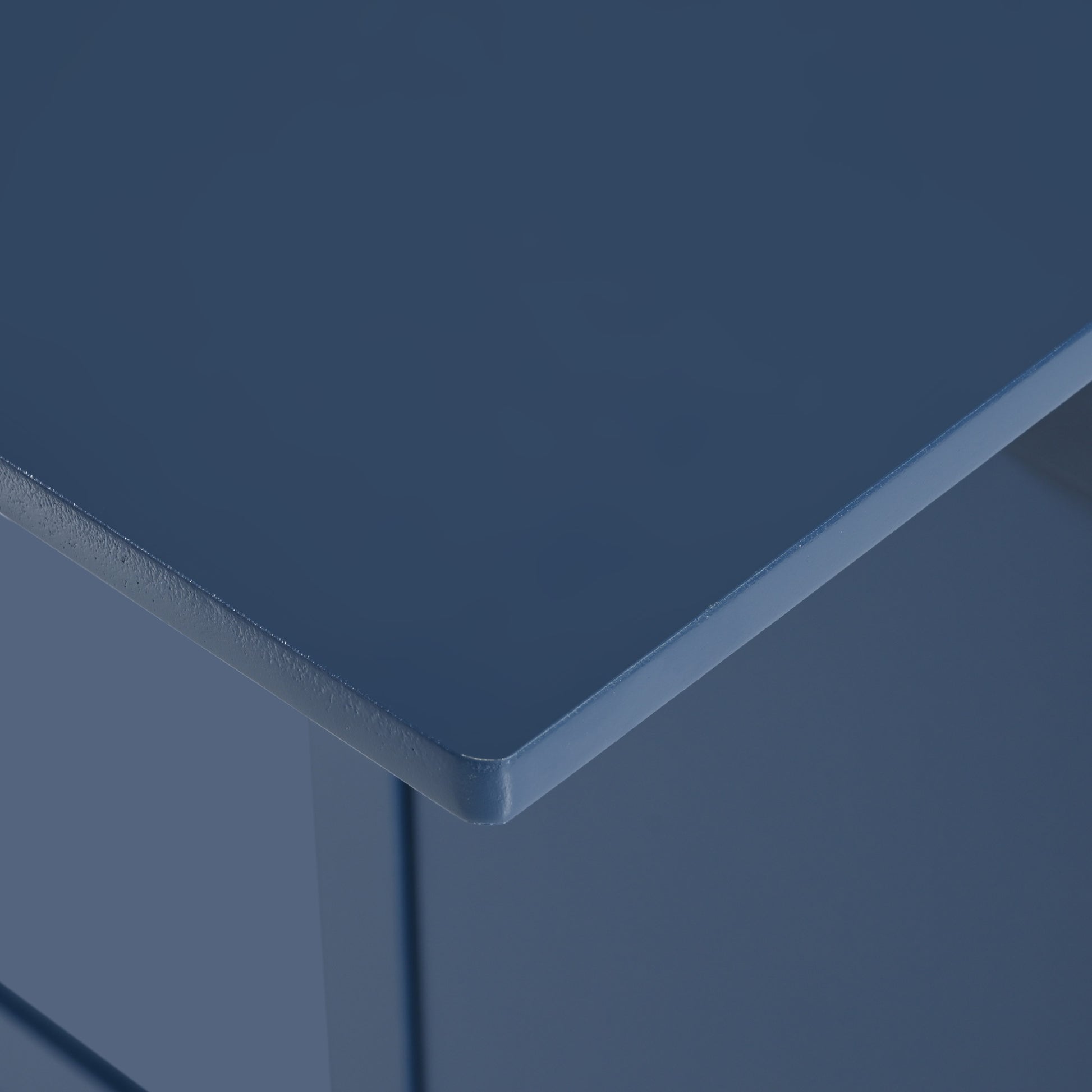Closeup of a navy blue wooden end table corner