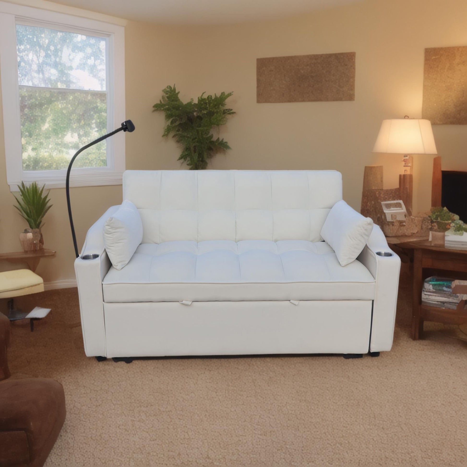 White faux leather sofa with tufted cushions featuring builtin cup holders