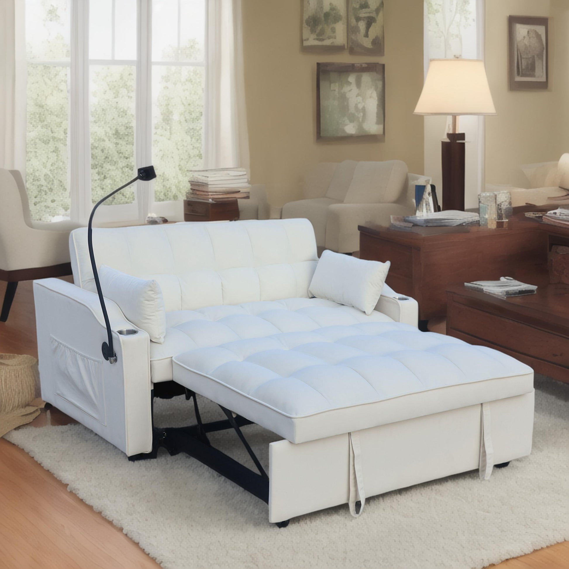 White leather pullout sofa bed with tufted mattress and armrest cup holders perfect for small spaces