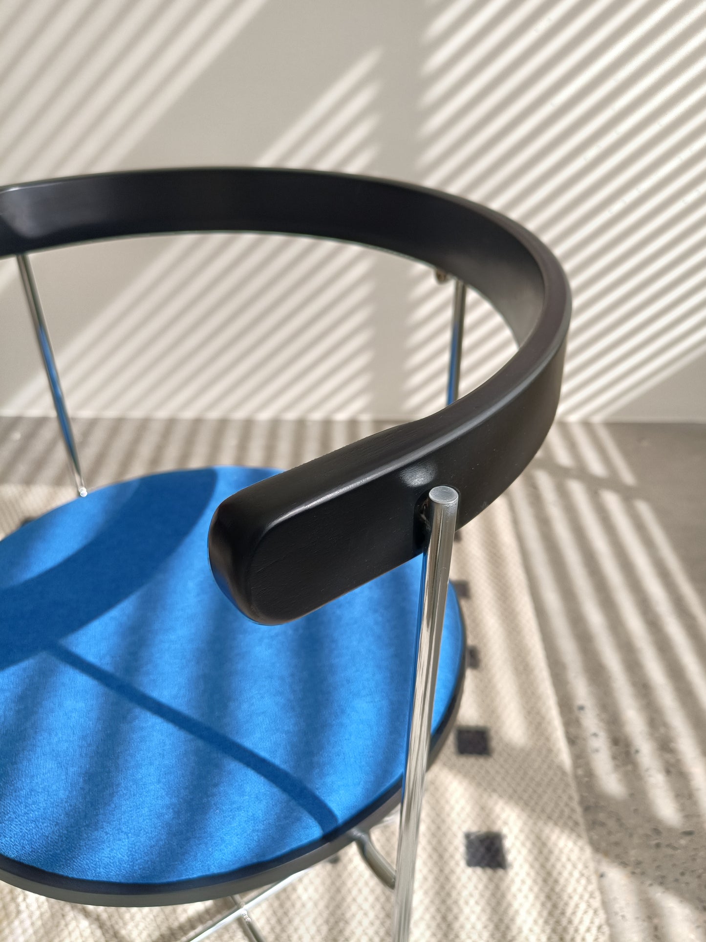 Modern black frame chair with a vibrant blue upholstered seat ideal for home offices
