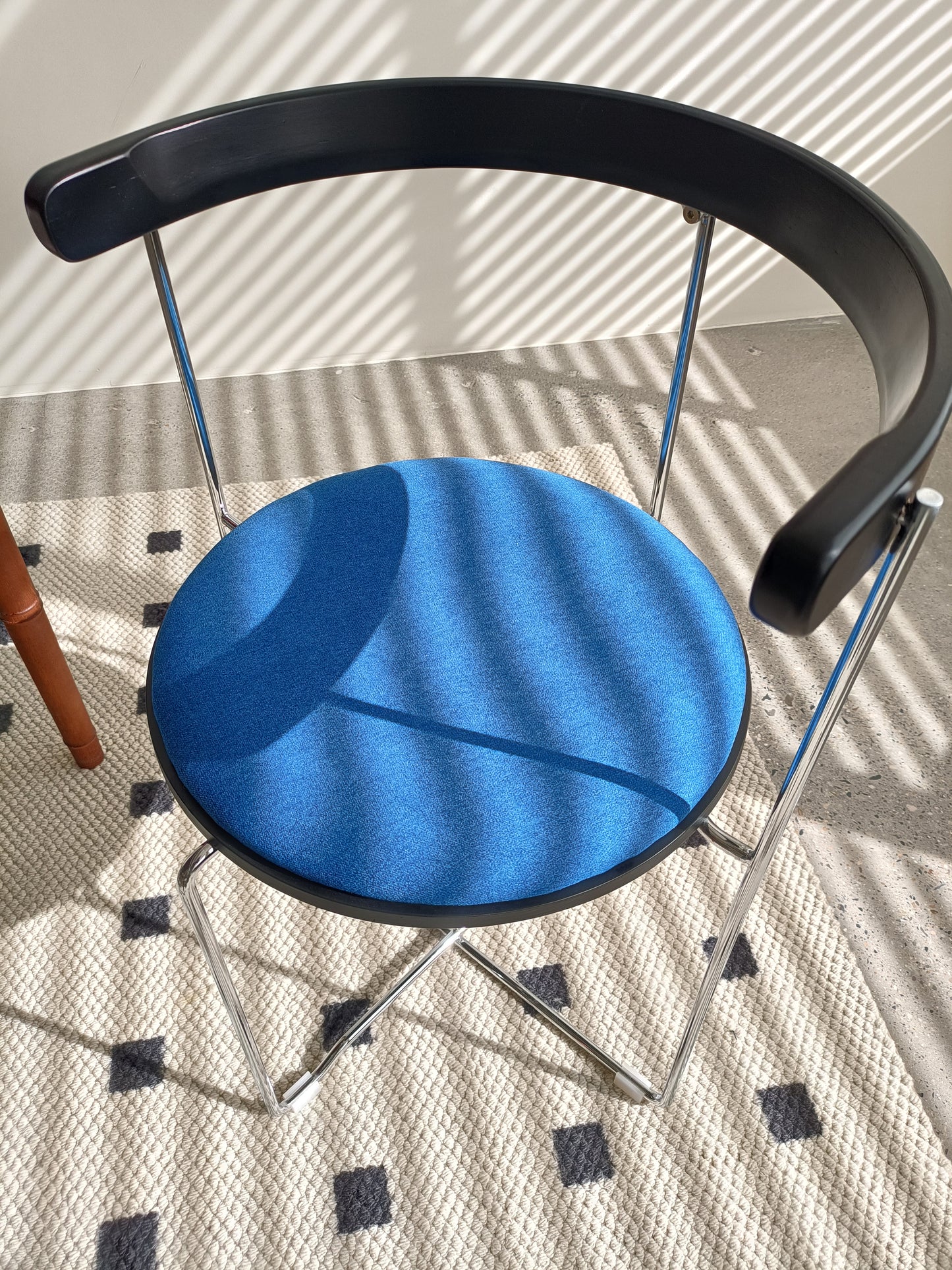Modern black bentwood chair with blue fabric seat and chrome legs