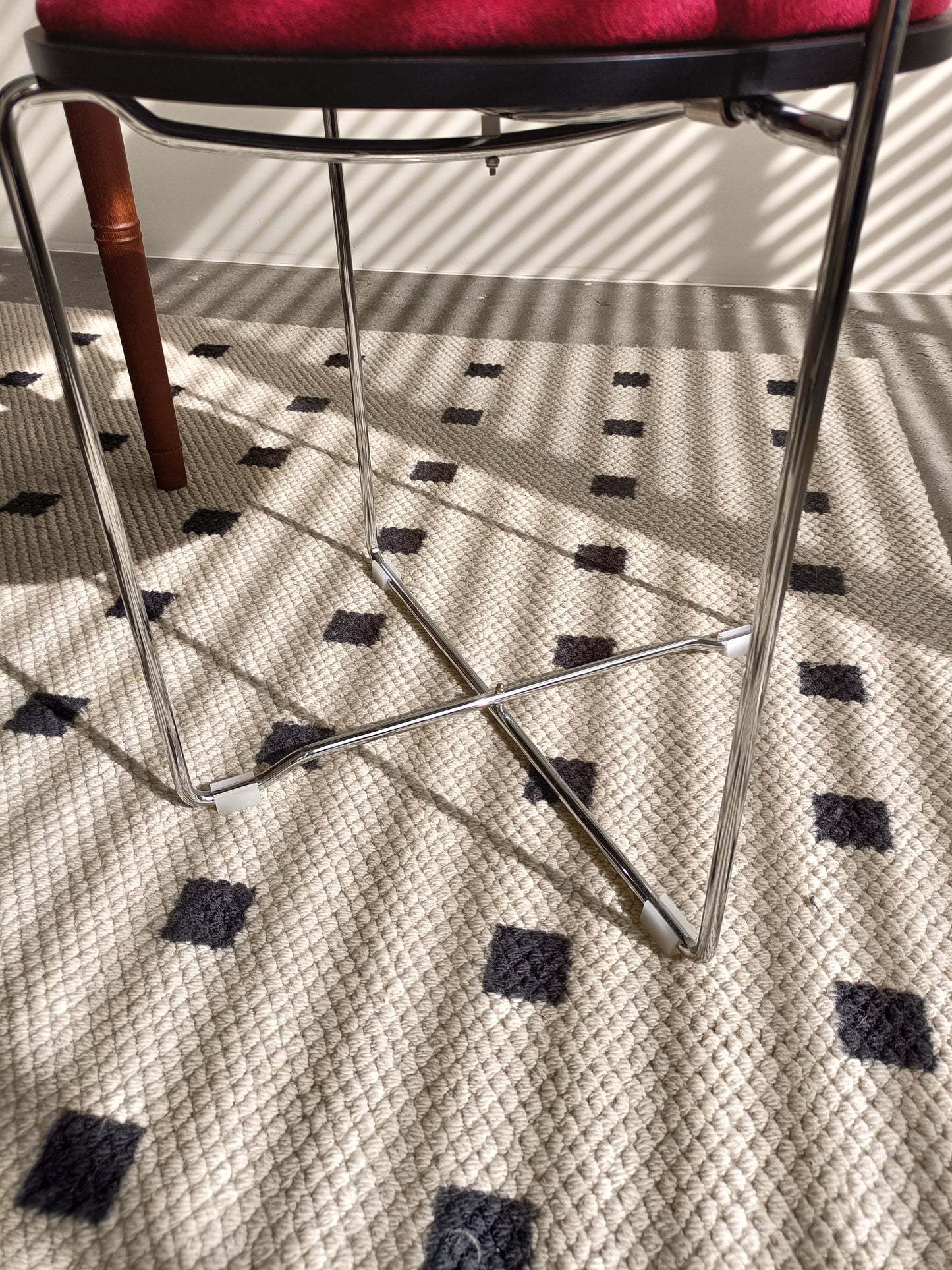 Modern chrome stool with red velvet seat minimalist design for contemporary kitchens