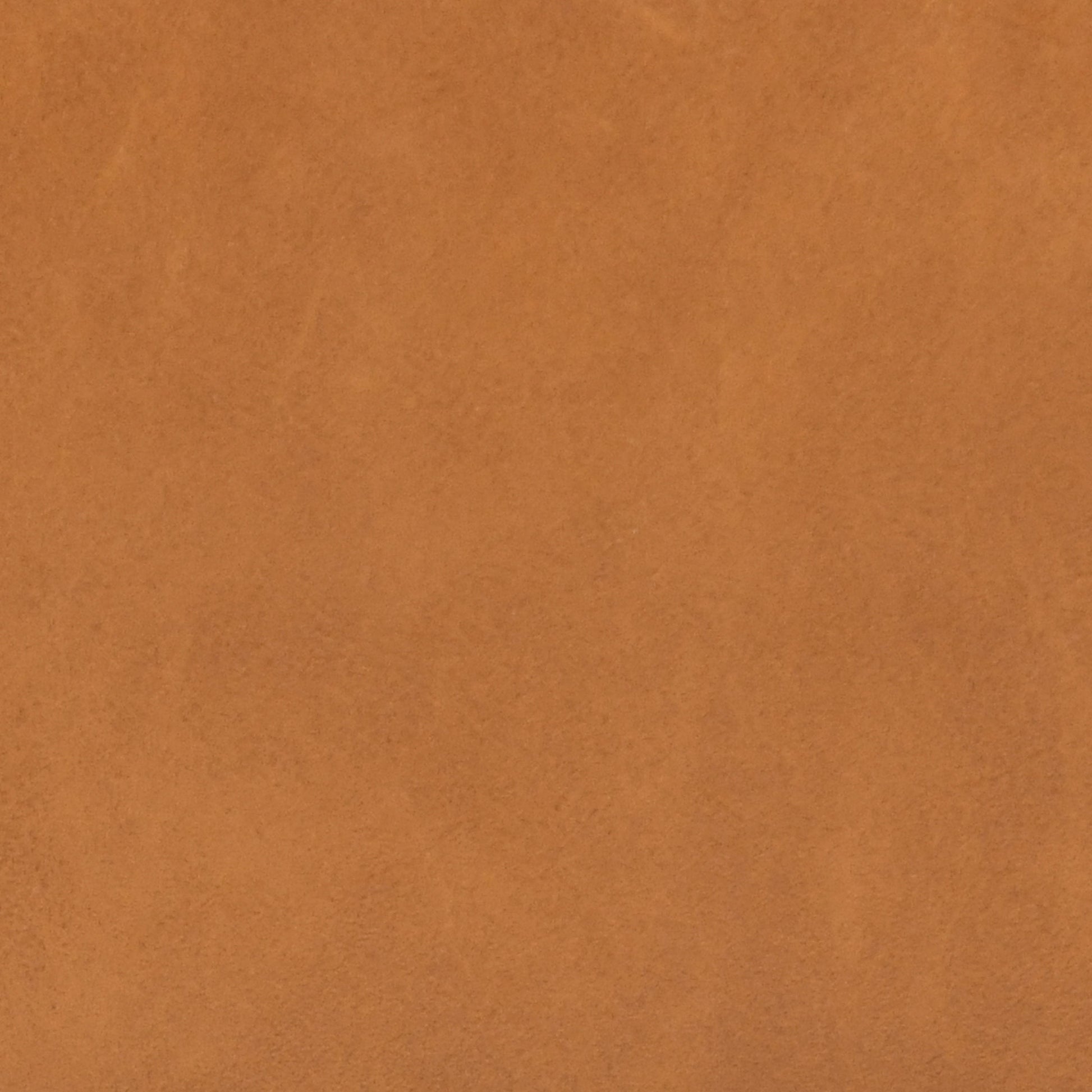 Closeup texture of smooth caramel brown leather upholstery material