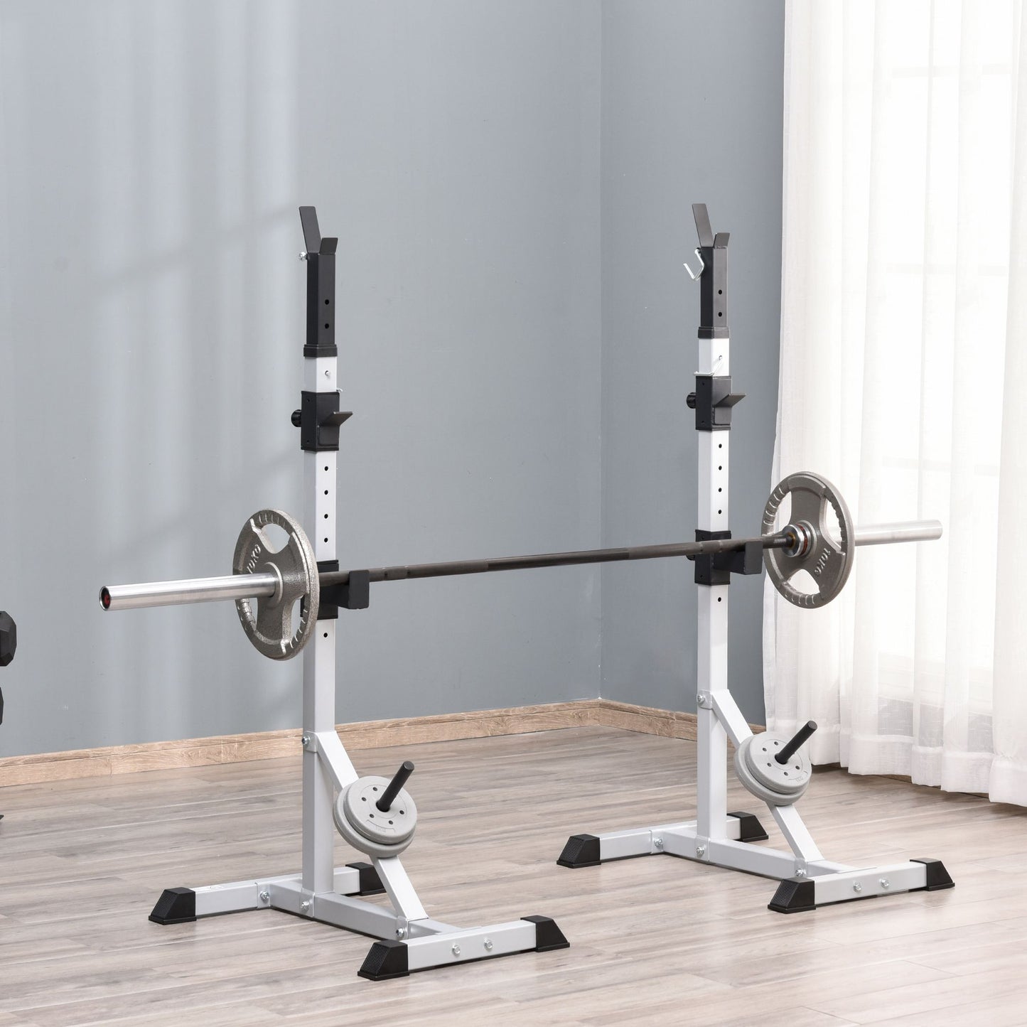 Adjustable squat rack with barbell and weight plates ideal for home gym