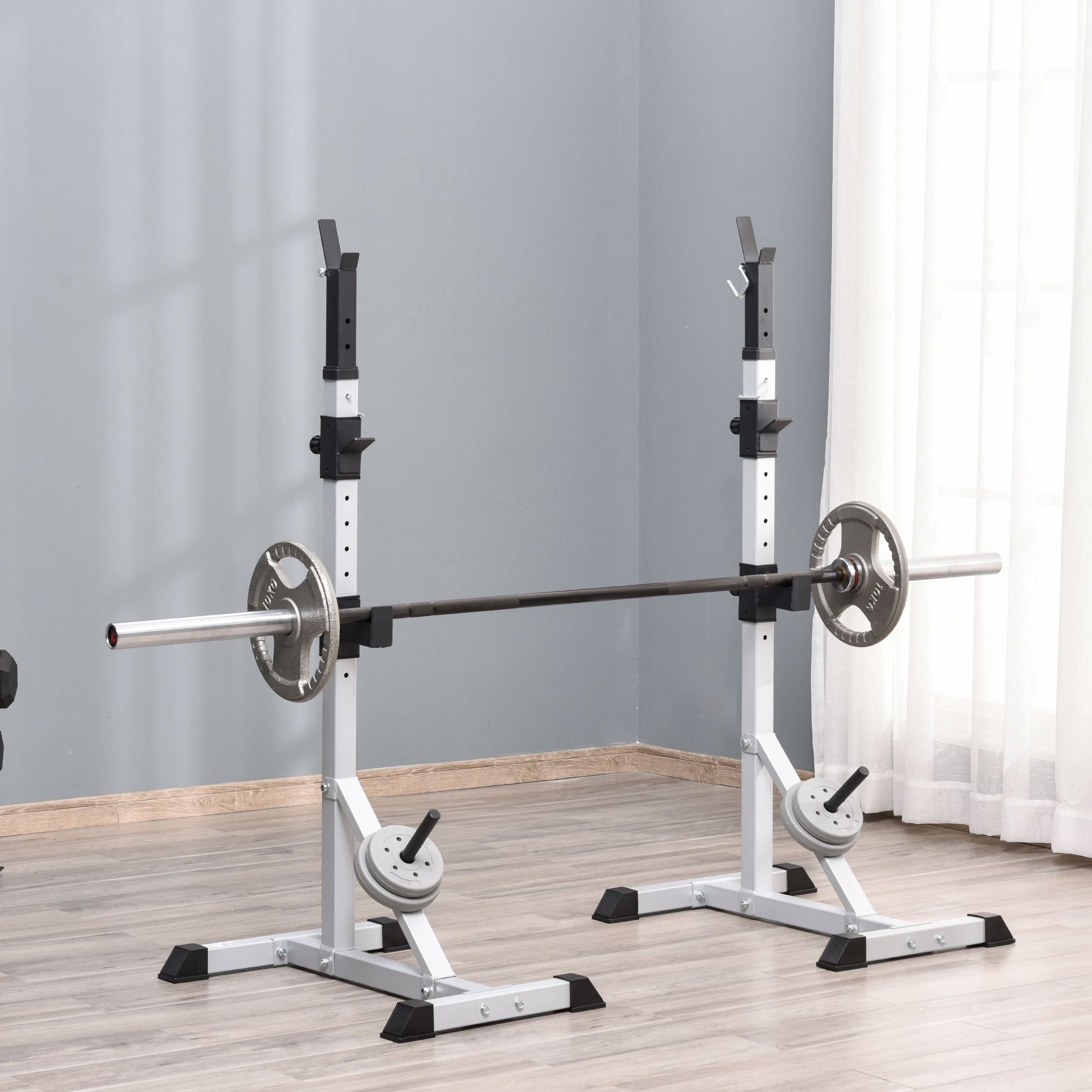 Adjustable squat rack with barbell and weight plates ideal for home gym