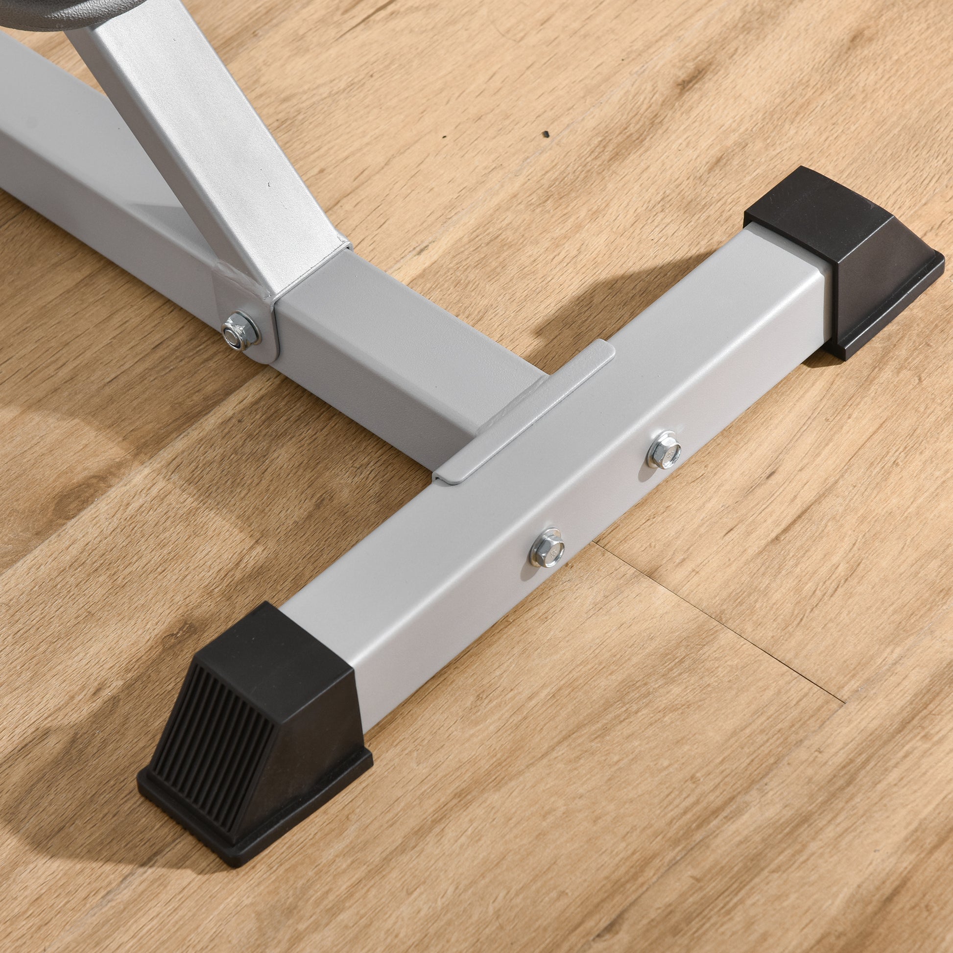Durable steel bench leg frame with black protective feet on wood floor