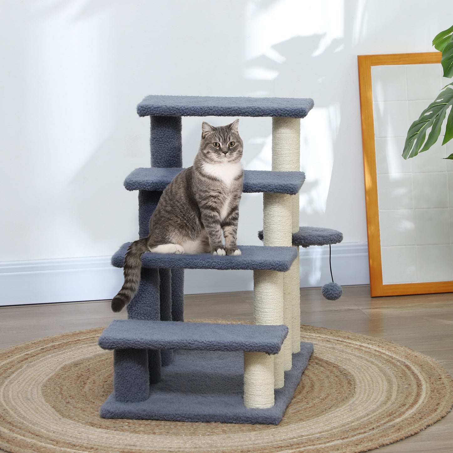 Multilevel grey cat tree with scratching posts and a playful cat