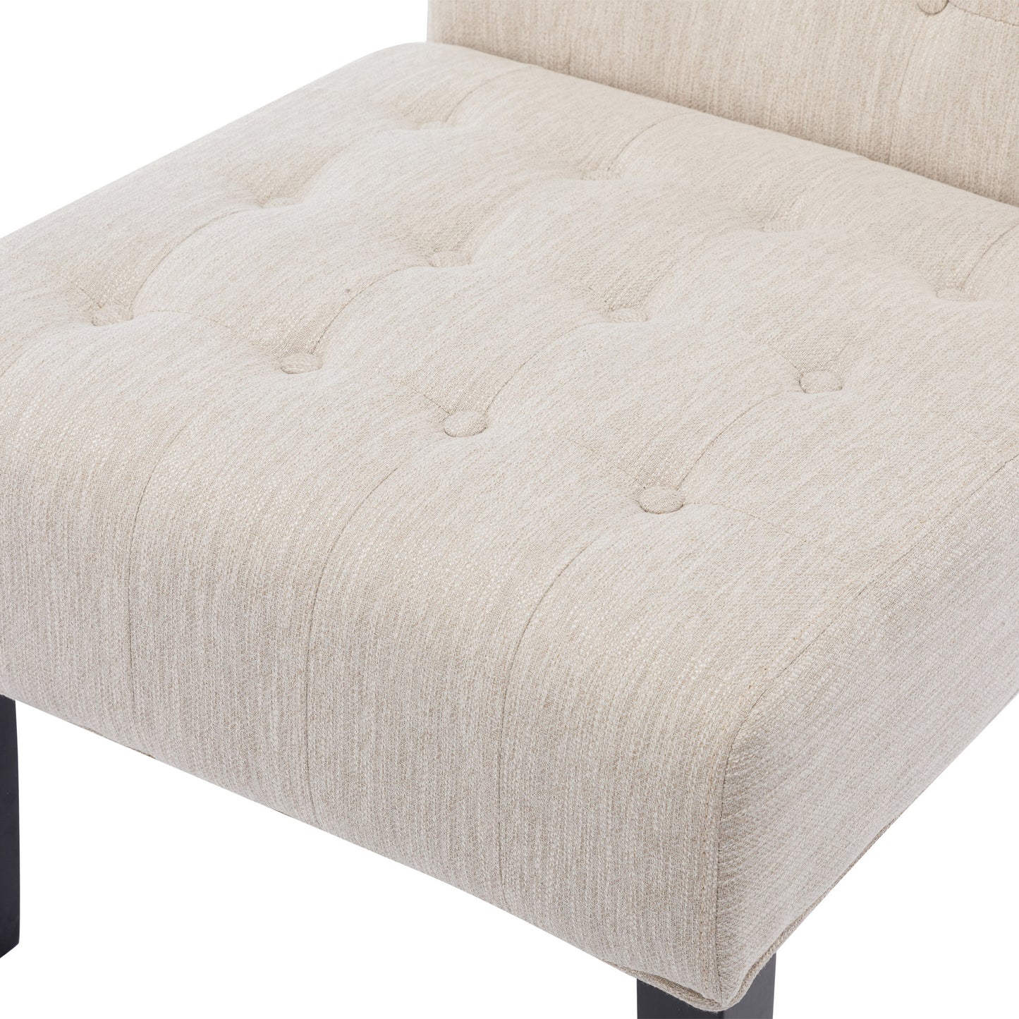 Beige linen upholstered armchair with deep button tufting and dark metal legs