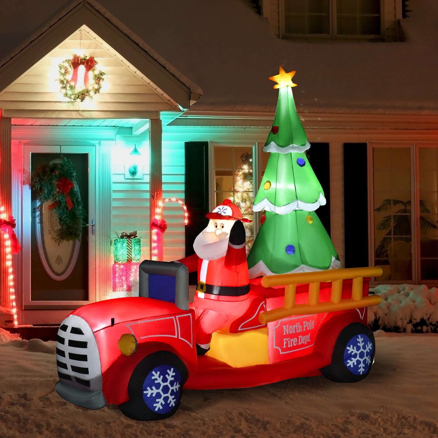 Inflatable Santa in a red fire truck with a Christmas tree perfect for holiday yard decor