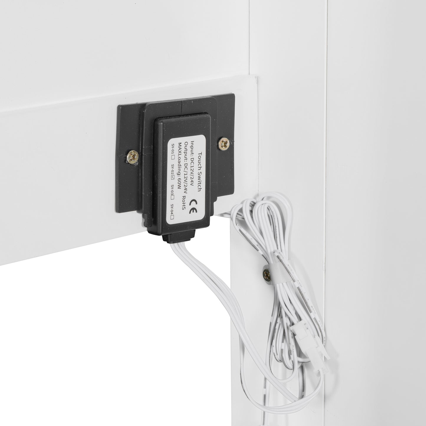 Black touch switch with white wires attached to a white surface