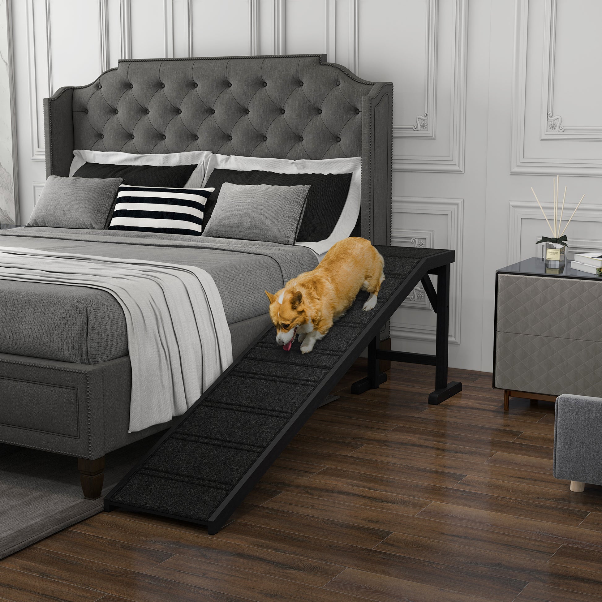 Black pet ramp with textured surface for dogs to easily access a bed