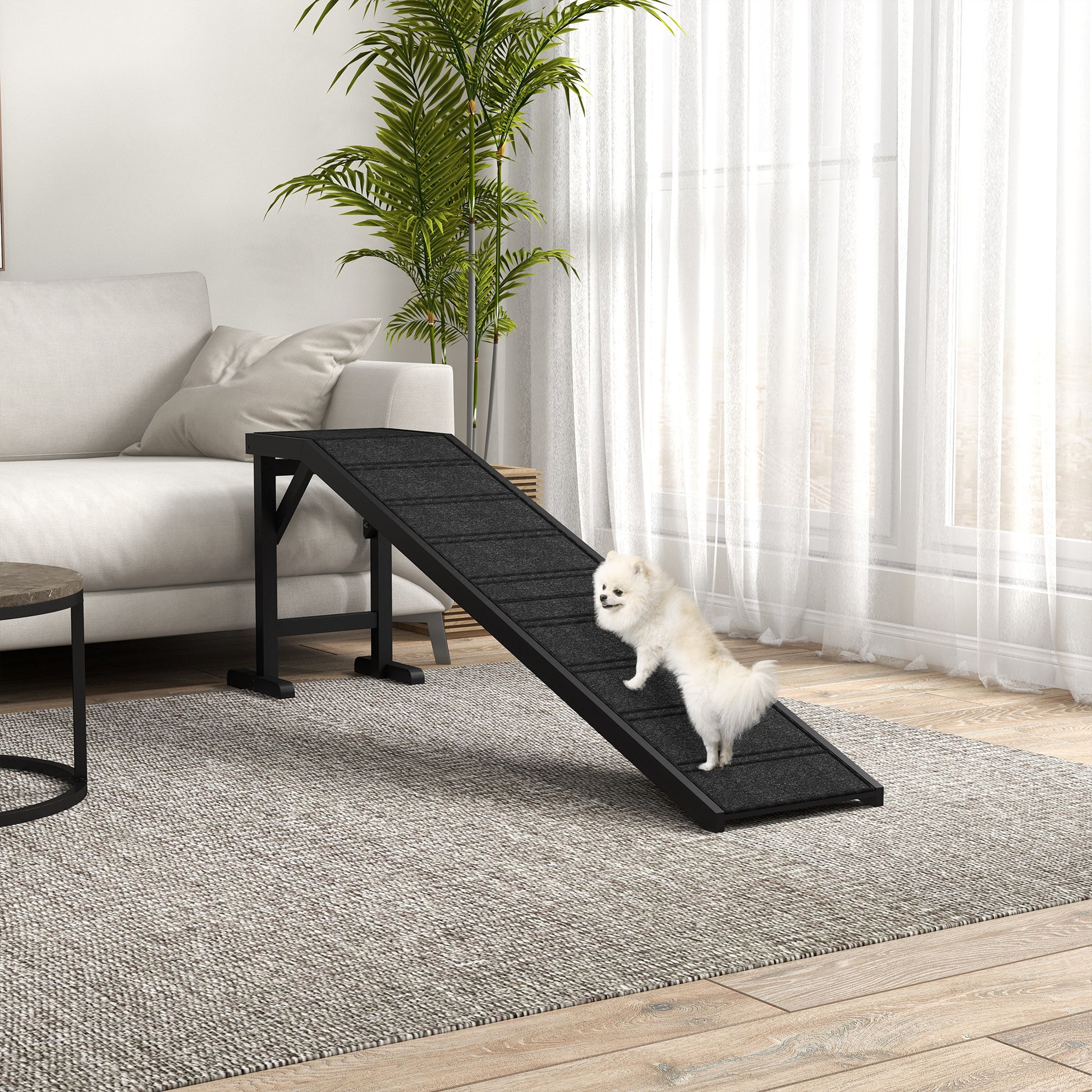 Black adjustable dog ramp with carpeted surface aiding small dogs on furniture