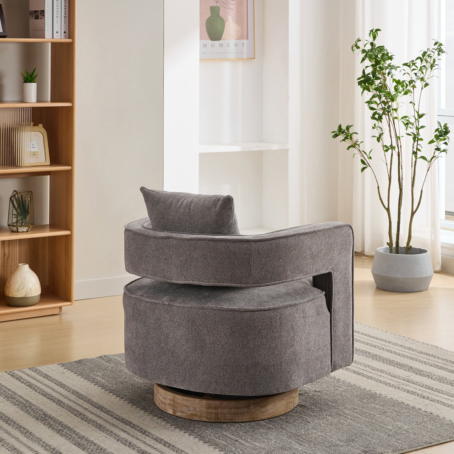 Grey upholstered swivel accent chair with plush cushion and wood base