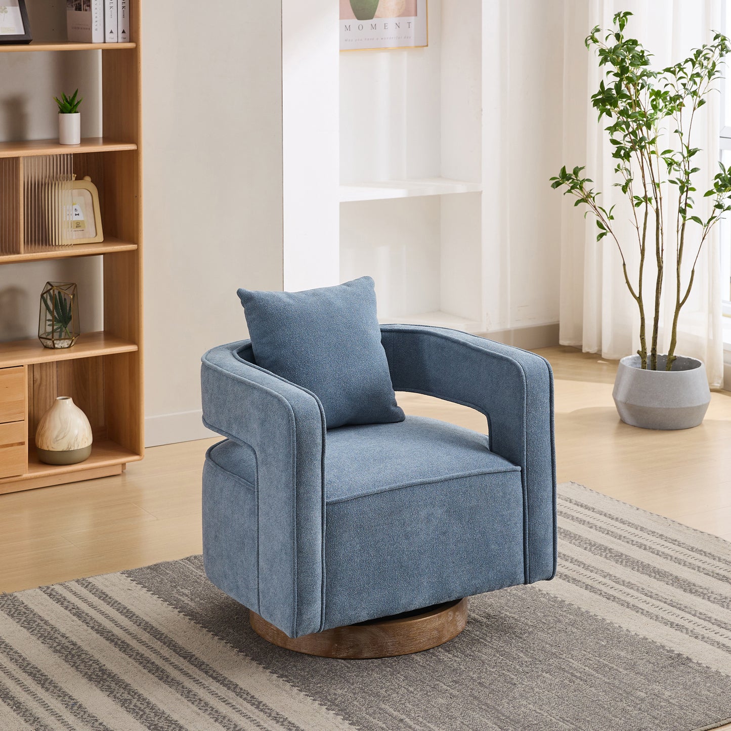Blue fabric accent chair with wooden swivel base and matching pillow