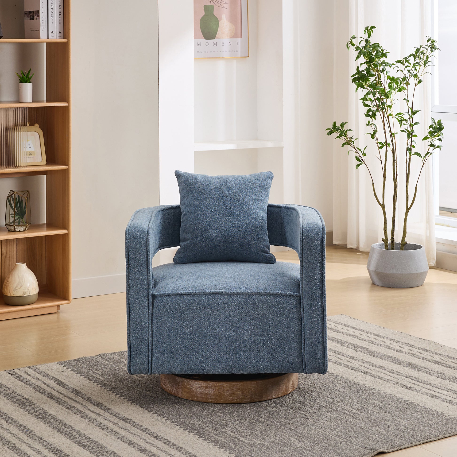 Blue swivel armchair with square lumbar pillow on textured rug
