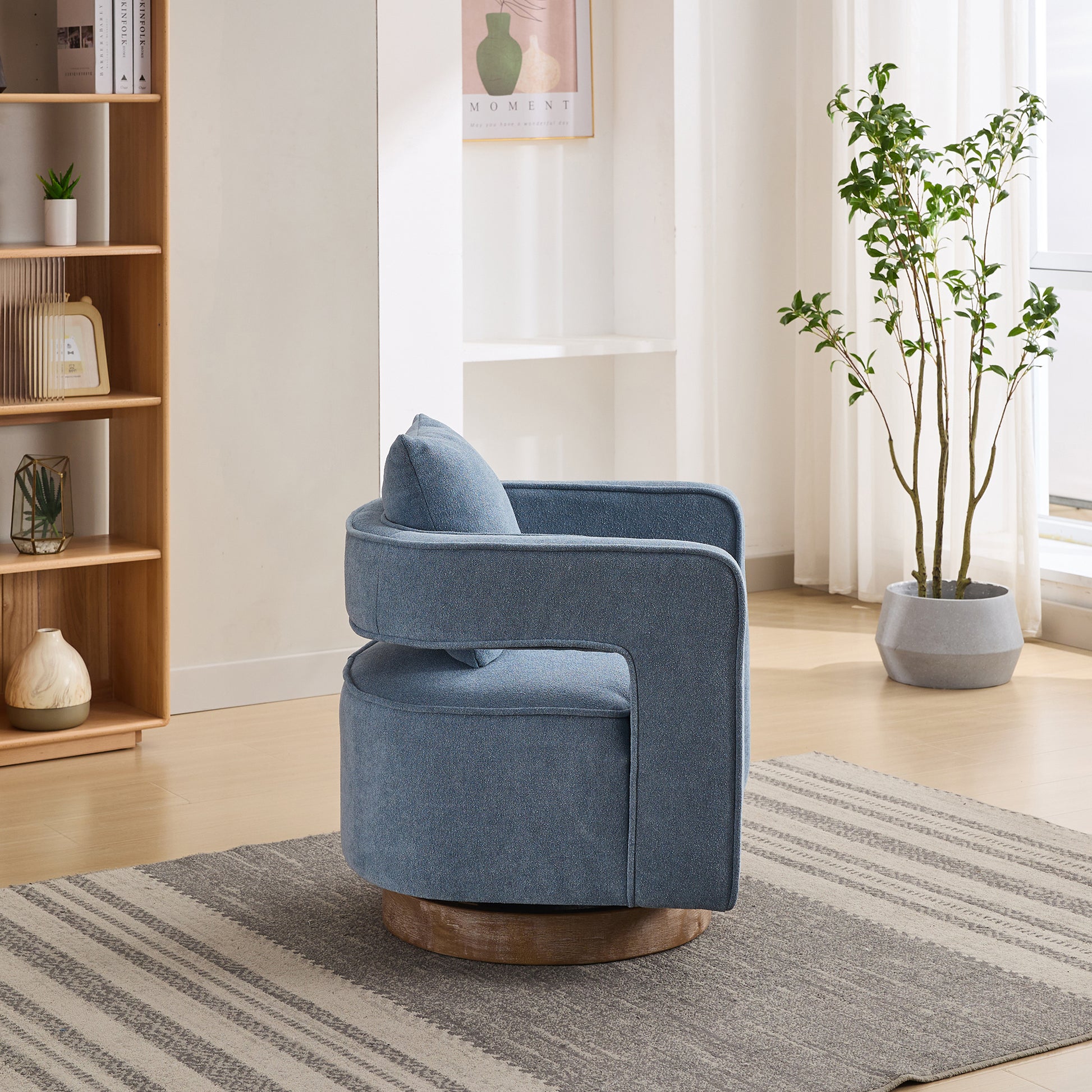 Blue upholstered swivel chair with modern curved design and wooden base