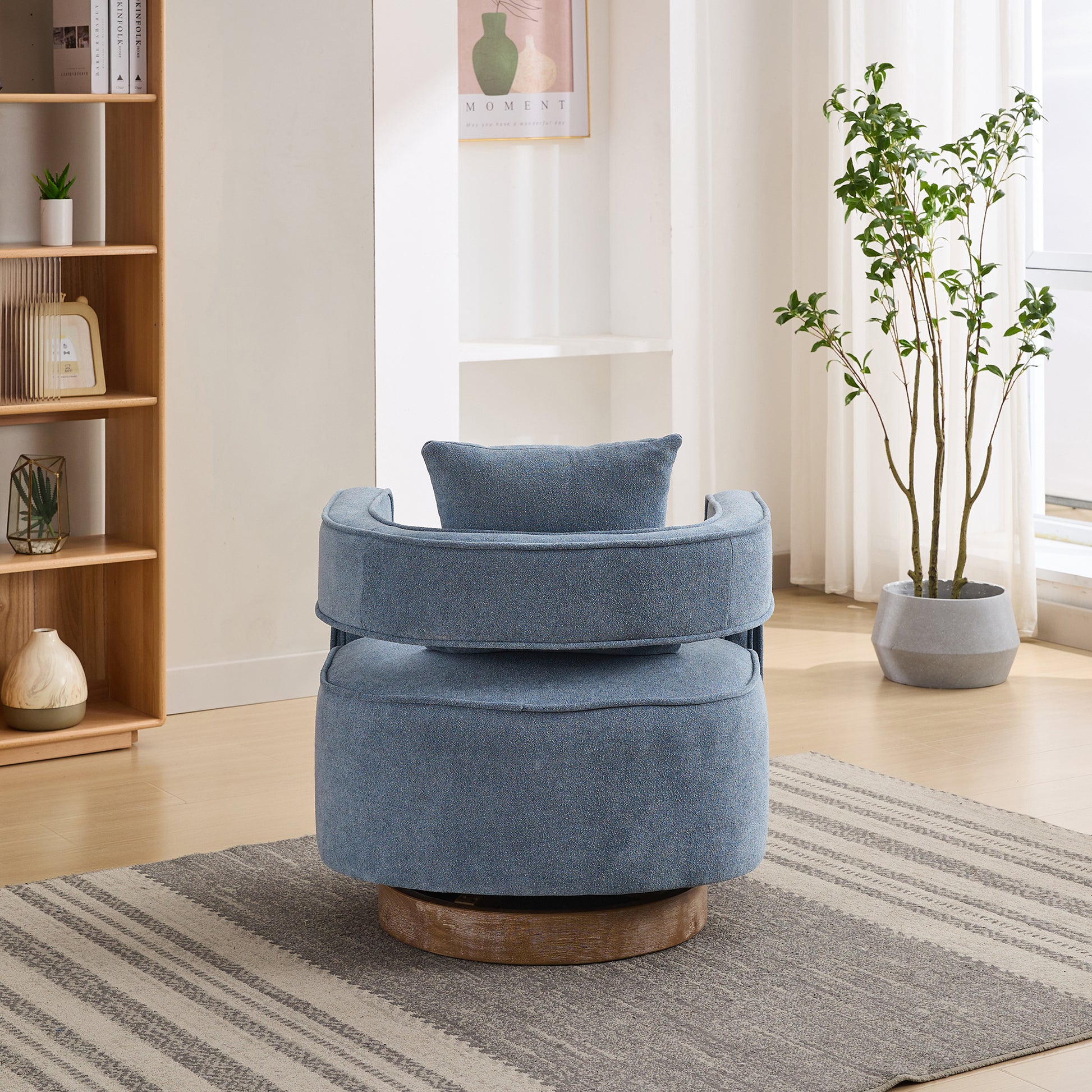 Blue swivel chair with textured fabric and a padded back cushion on a wooden base