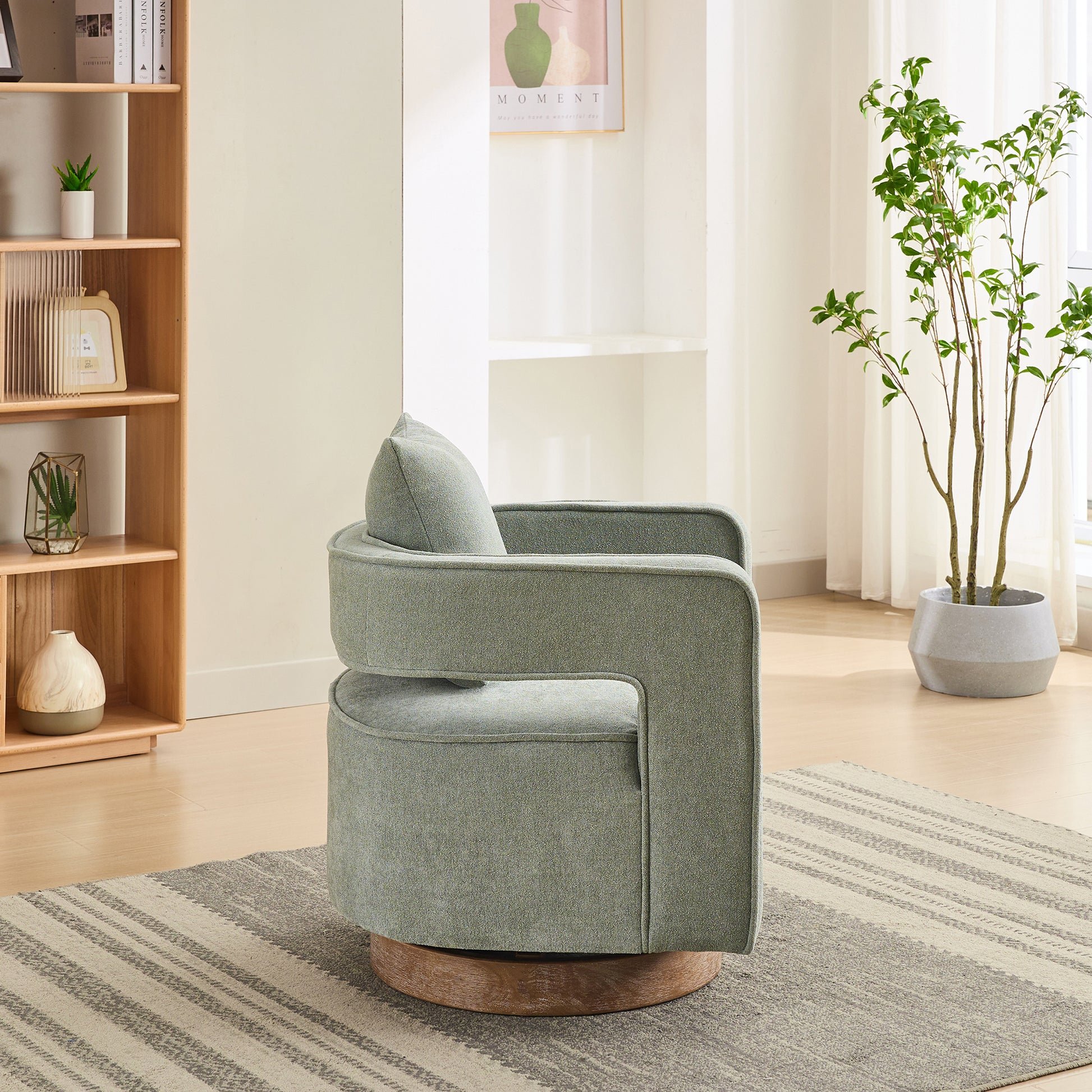 Sage green swivel accent chair with plush upholstery and a wooden base perfect for living rooms