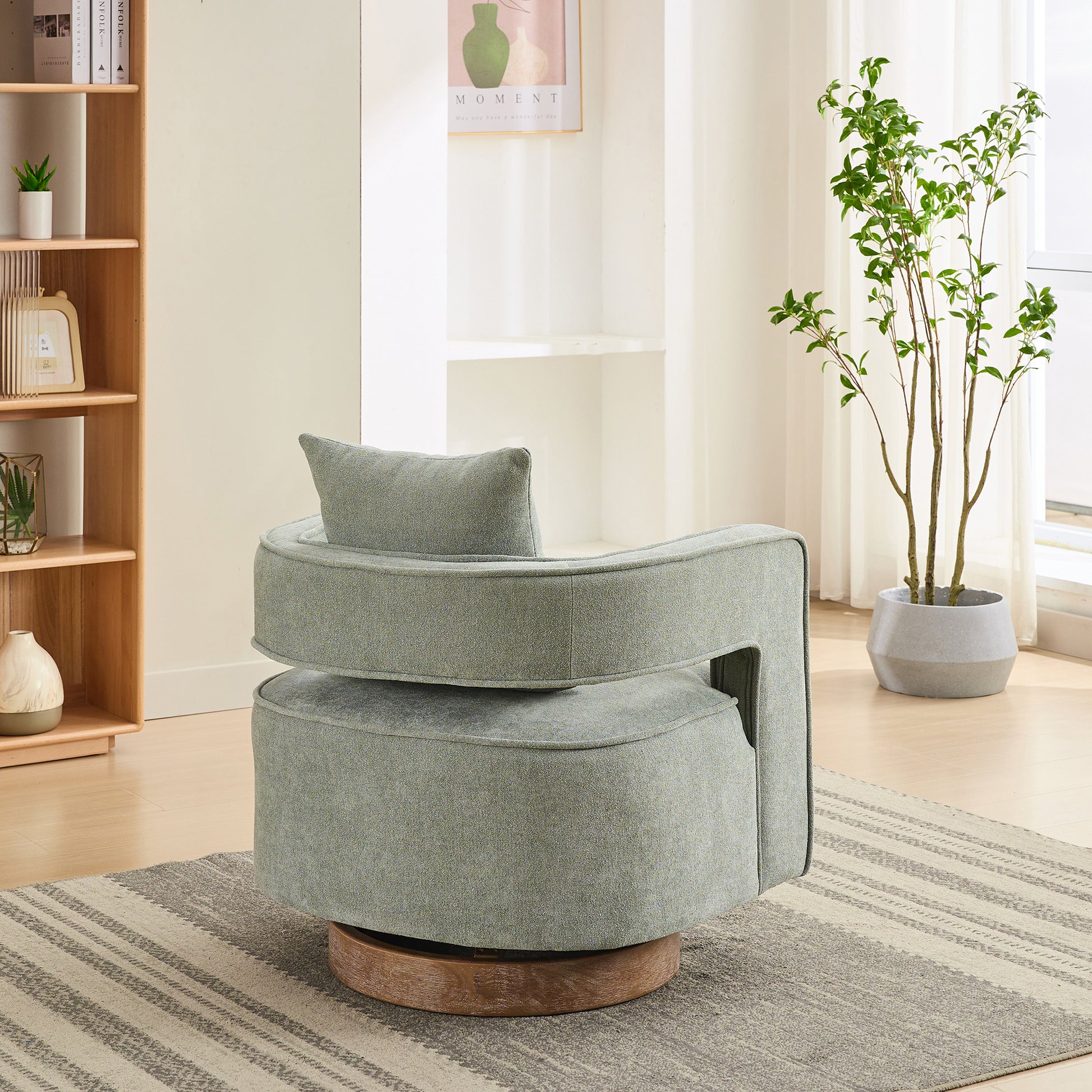 Modern swivel armchair in textured sage green fabric with natural wood base