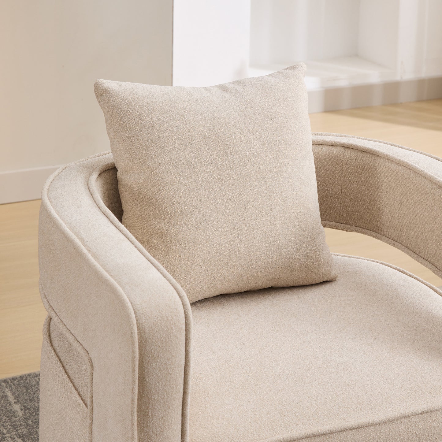 Cream boucle fabric armchair with rounded arms and plush cushion