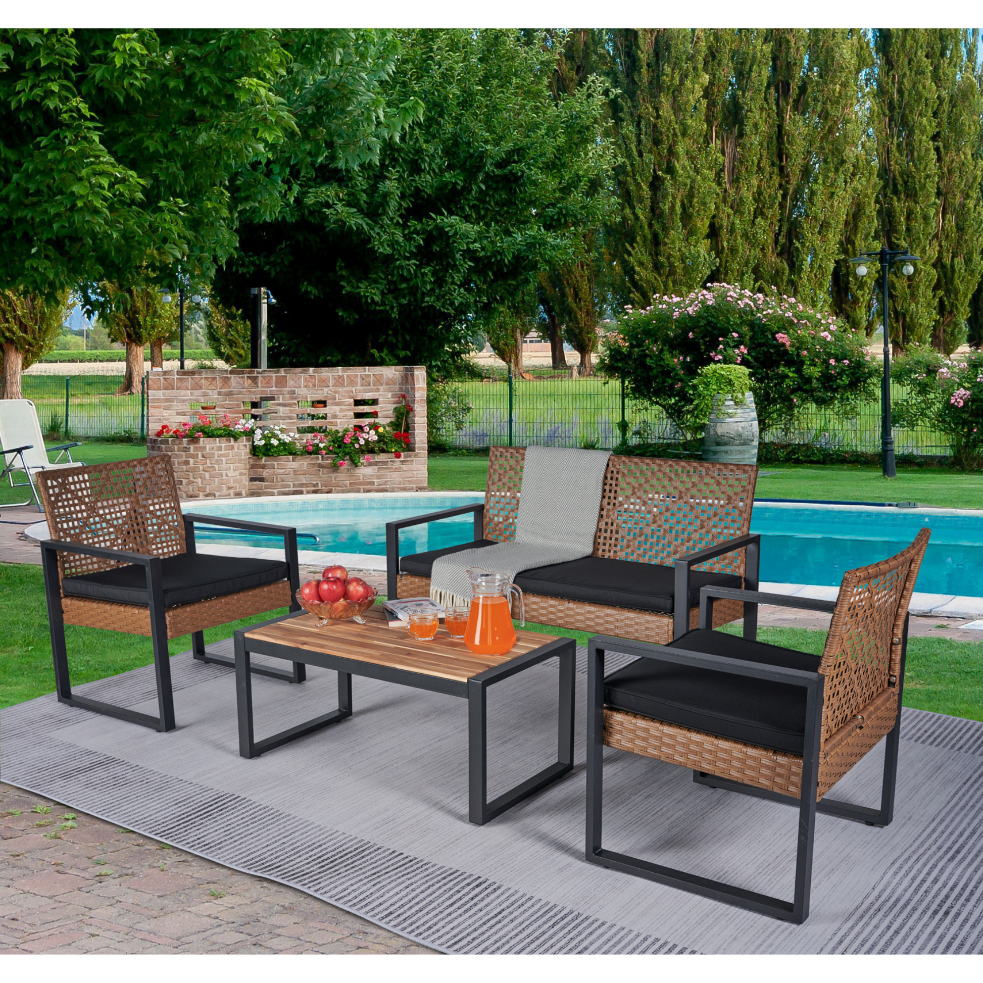 Brown rattan patio furniture set with black cushions beside a pool