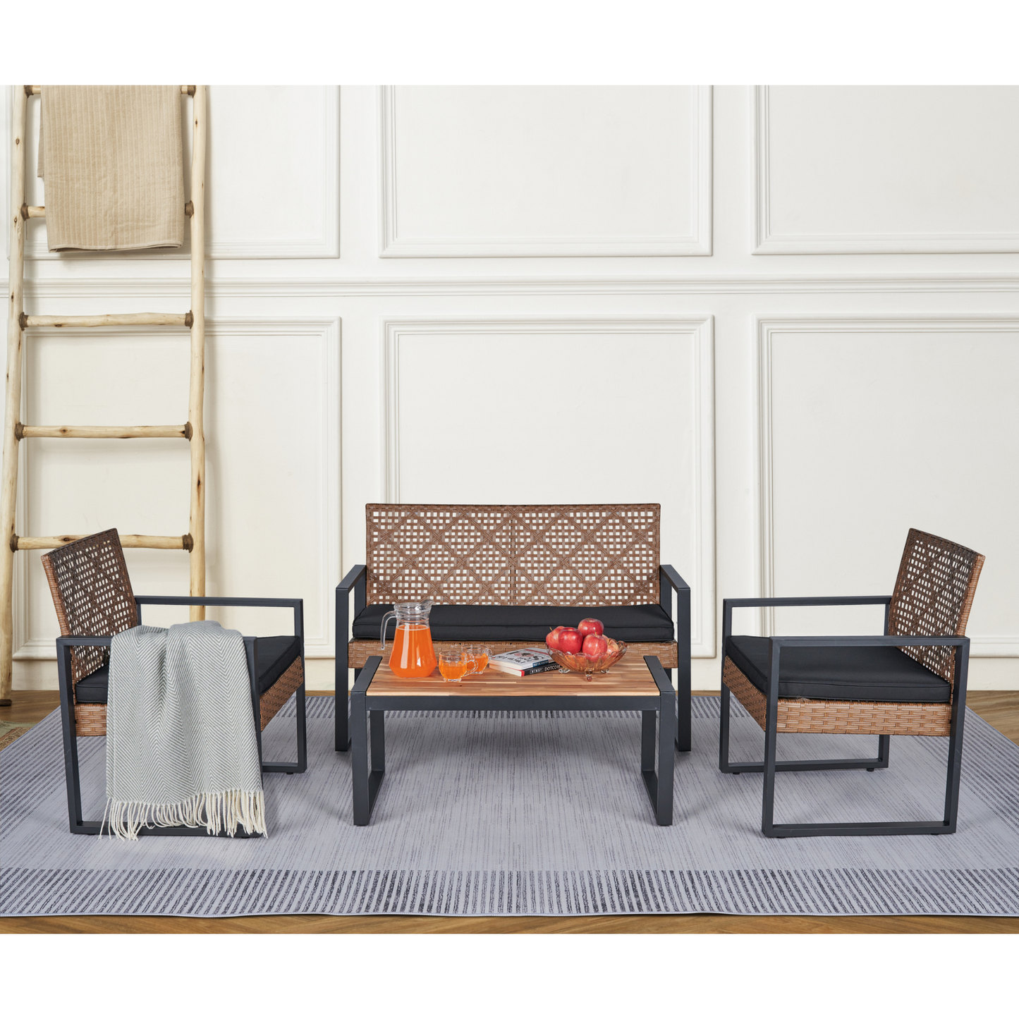 Woven rattan patio furniture set with black cushions and coffee table
